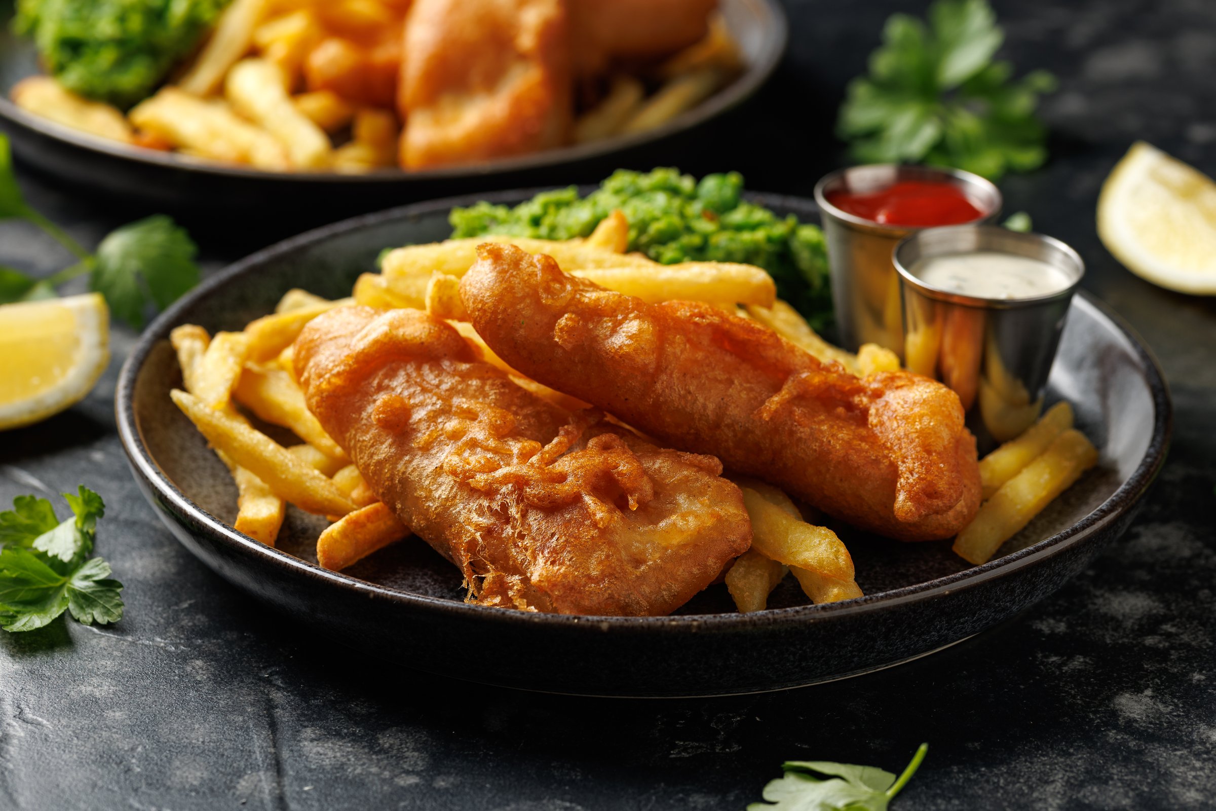 British Fish and chips with mashed peas, tartar and ketchup sauce