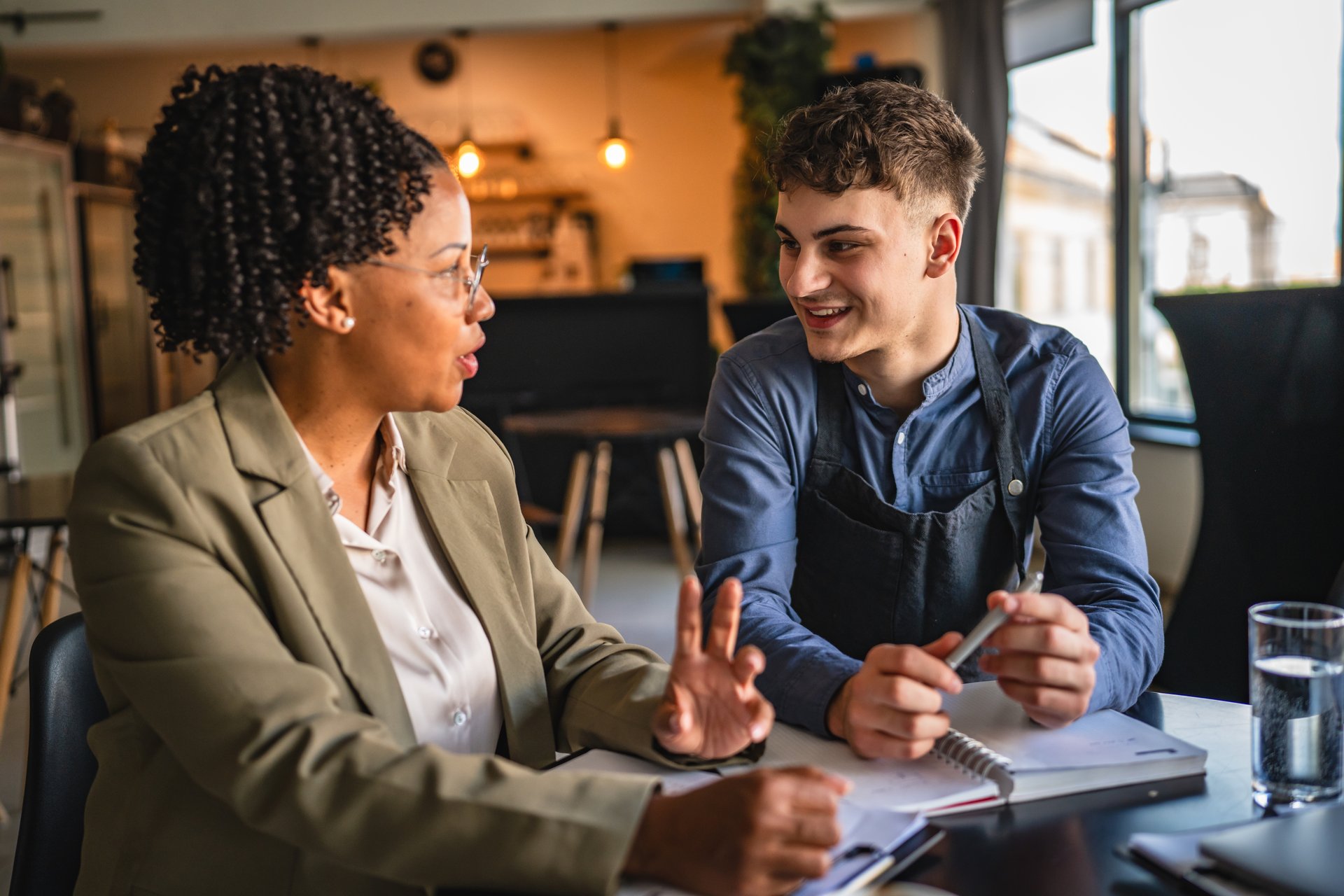 young man entrepreneur on the meeting with african american female financial adviser analyze and design the project