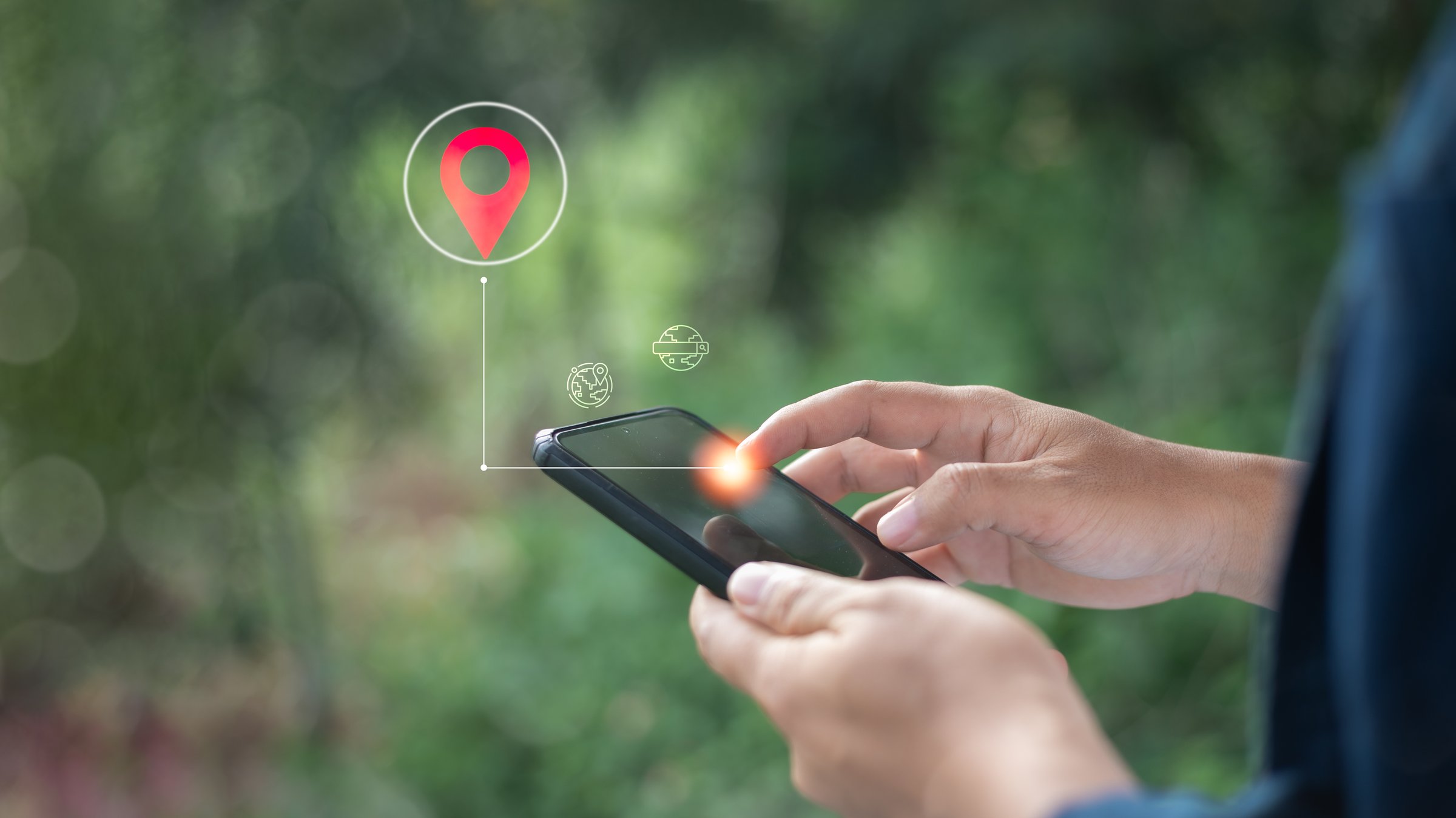 Close-up of a hand using a smartphone with a GPS location pin icon, representing mobile navigation, geolocation tracking, and real-time positioning in smart technology.