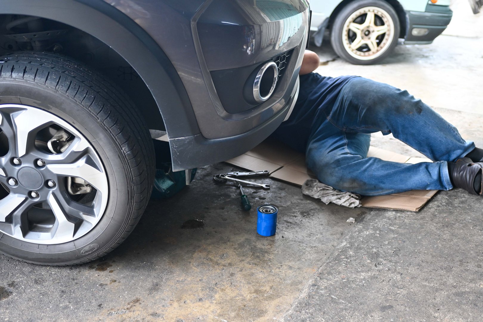 Mobile mechanic working on car