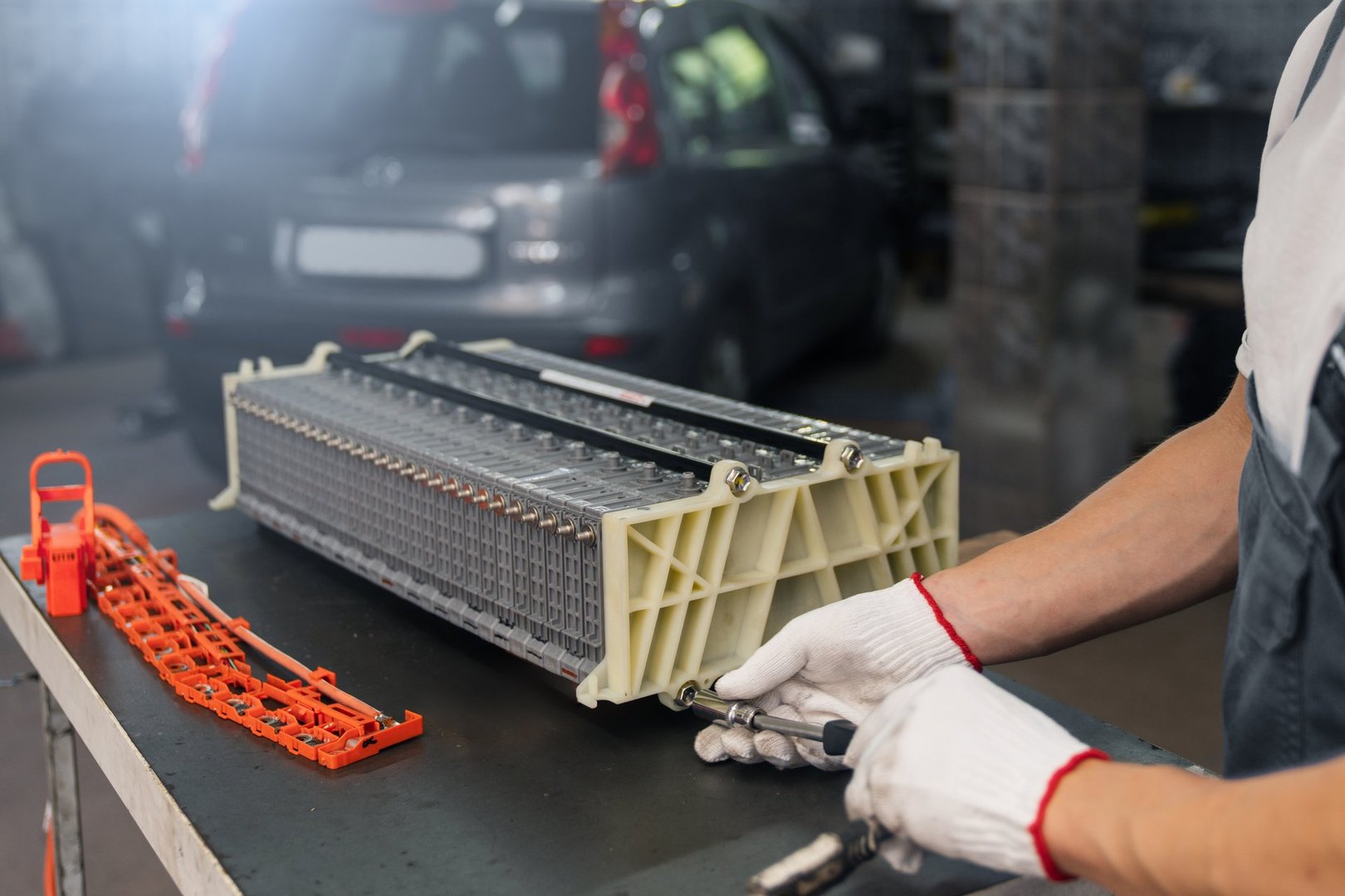 Serviceman repairs electric battery pack of hybrid car