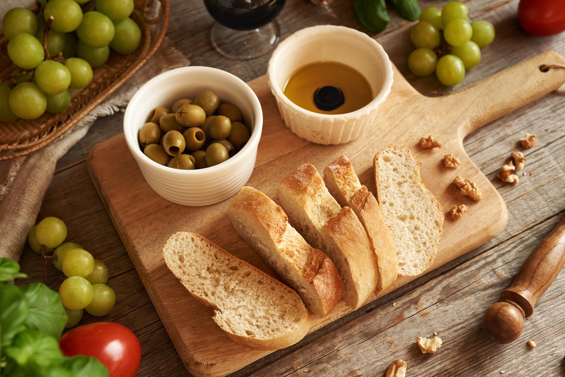 Italian ciabatta bread with balsamic vinegar in olive oil, grapes and walnuts