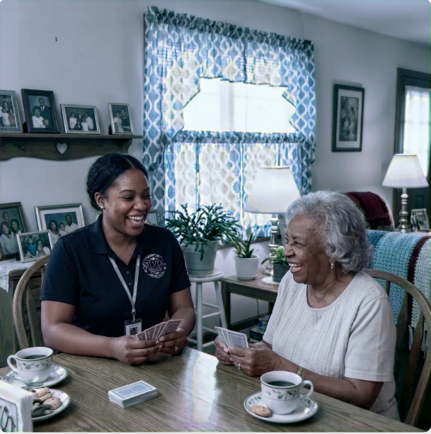 Senior woman and home health aide socializing