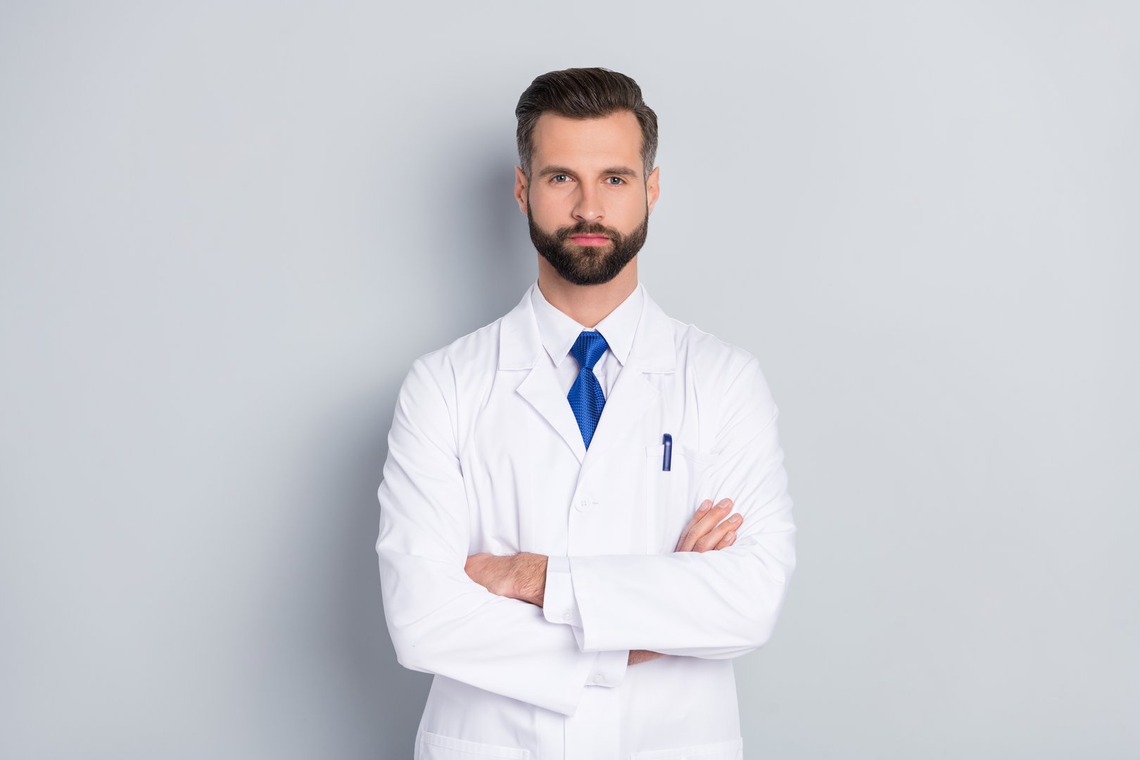 Portrait of attractive skilled smart experienced successful medic director professor folded arms isolated on grey color pastel background.