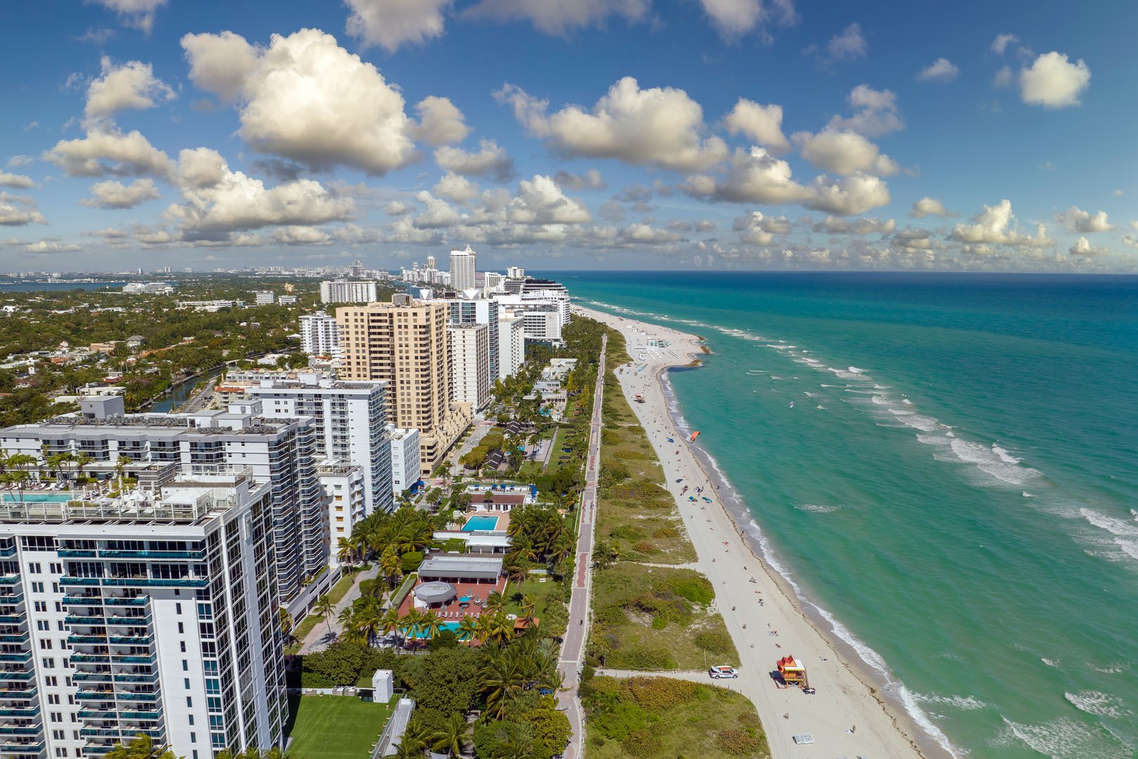 Miami Beach city with high luxury hotels and condos and sandy beachfront.