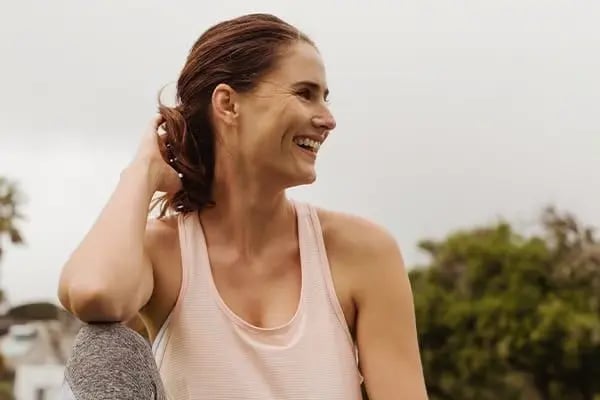 Confident woman displaying healthy smile after comprehensive general dentistry care including cleanings and preventive treatments