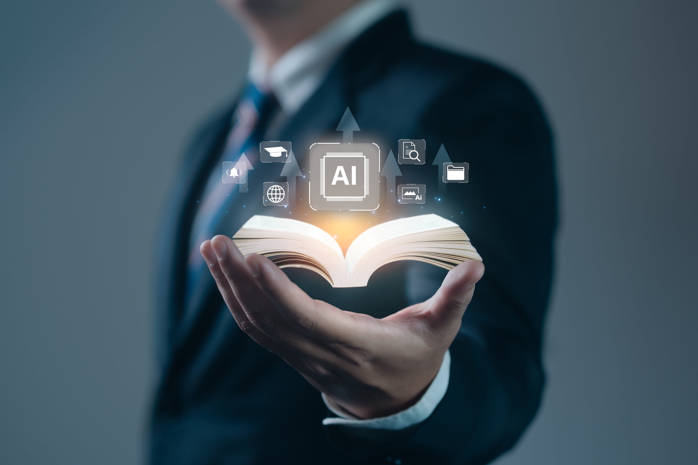 AI Education Book on hand of businessman with icon AI Education
