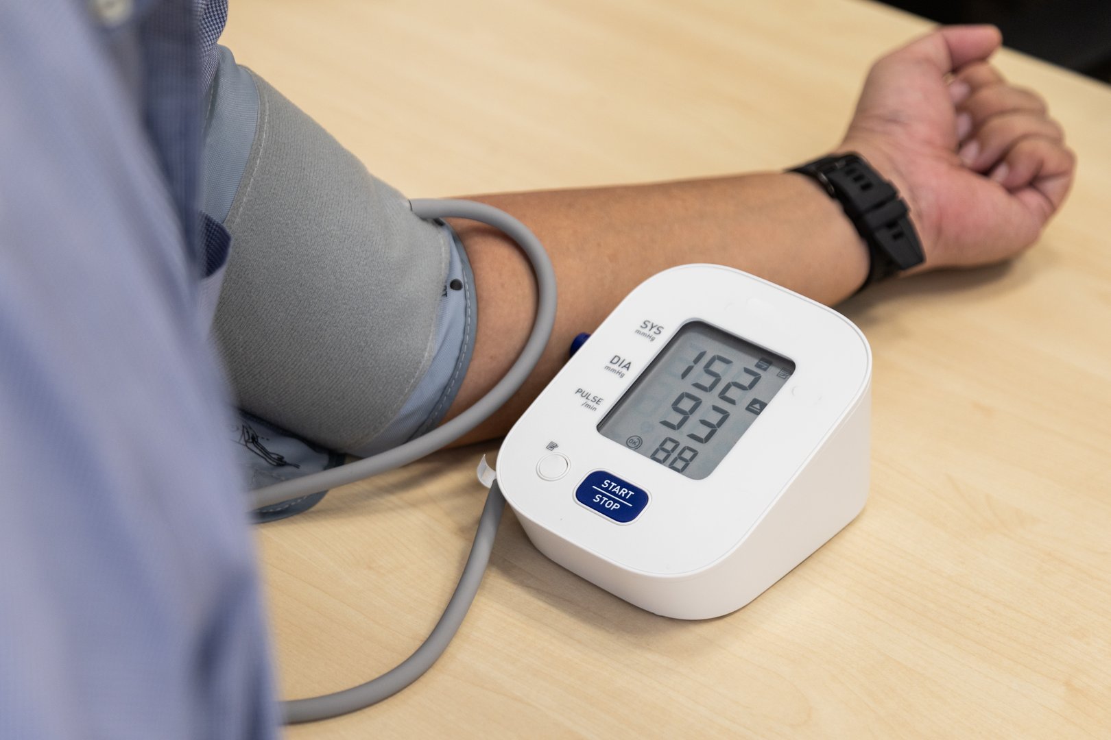 Stressful Asian man blood pressure examination result suggested hypertension with high systolic and diastolic readings