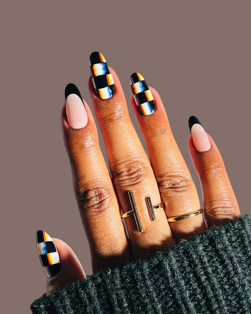 A detailed close-up of a young woman's hands featuring a modern manicure with a unique nail art style. The design combines elegant shapes, trendy colors, and creative details to reflect a fresh and fashionable look. This contemporary nail art highlights individuality, beauty, and self-expression, making it ideal for concepts related to fashion editorials, beauty industry promotions, nail salons, and skincare or lifestyle campaigns. The clean background and professional finish emphasize the artistic quality of the manicure, giving the image a refined and stylish appeal.