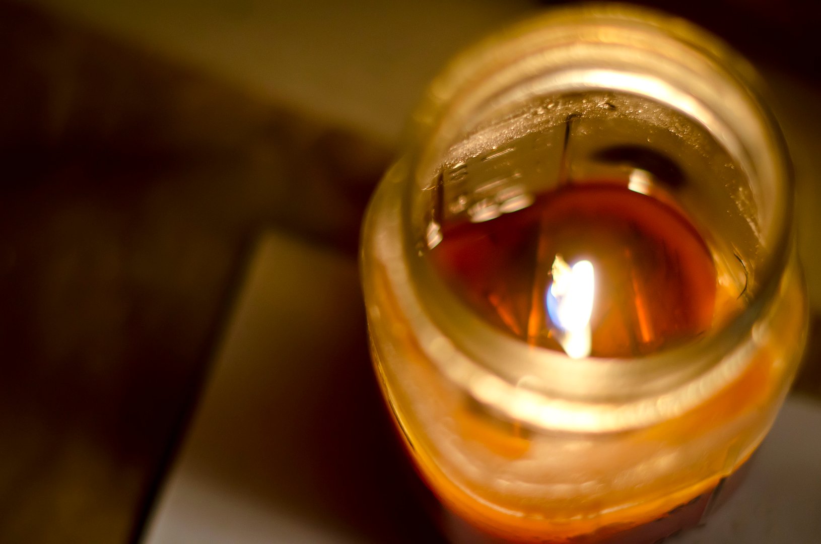 A top down view of a candle flame inside of a mason jar