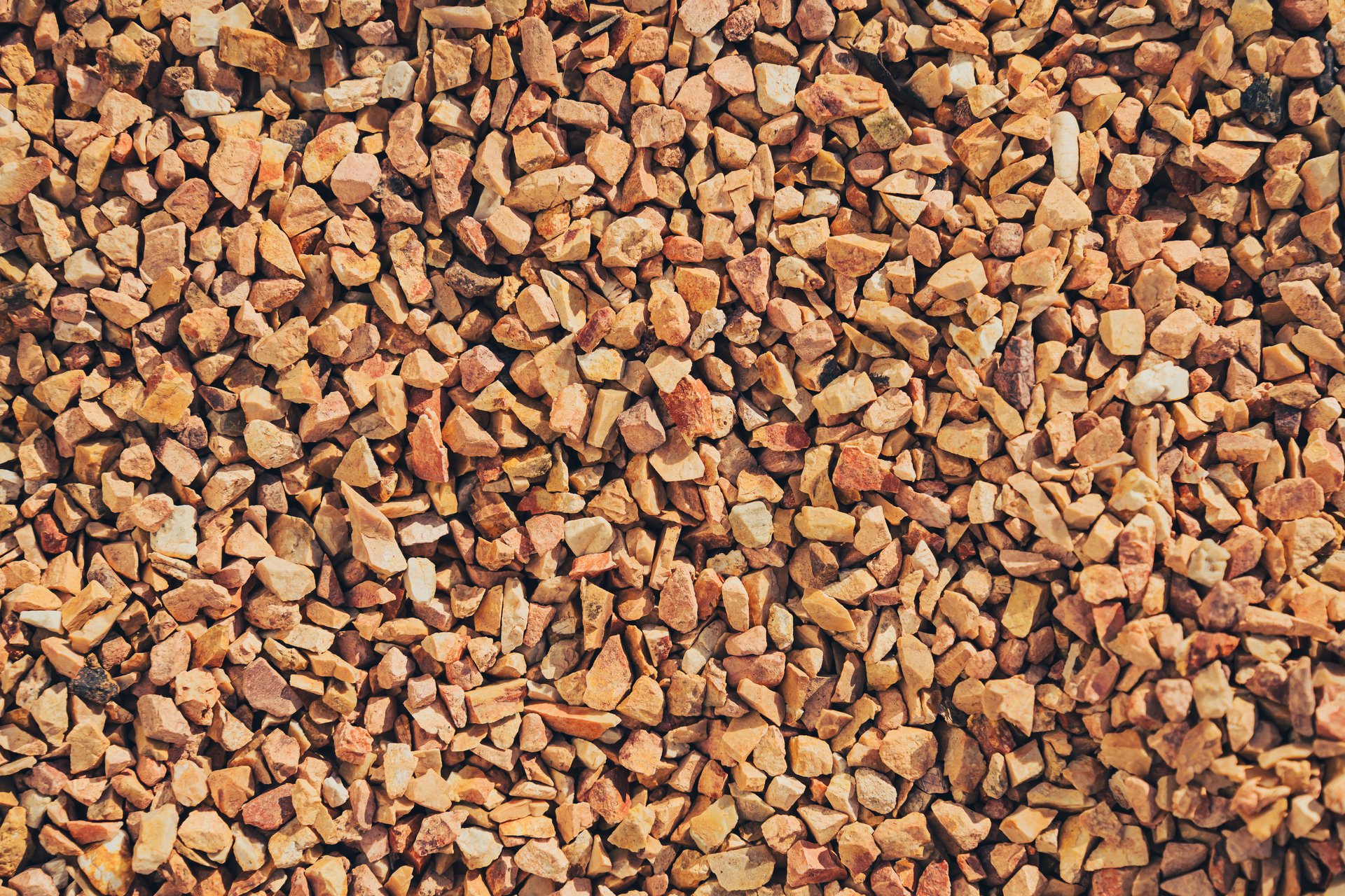 A Gravel texture background with small, irregular stones earthy tones. This natural material is often used landscaping, construction, and decorative purposes, adding rustic touch to various projects