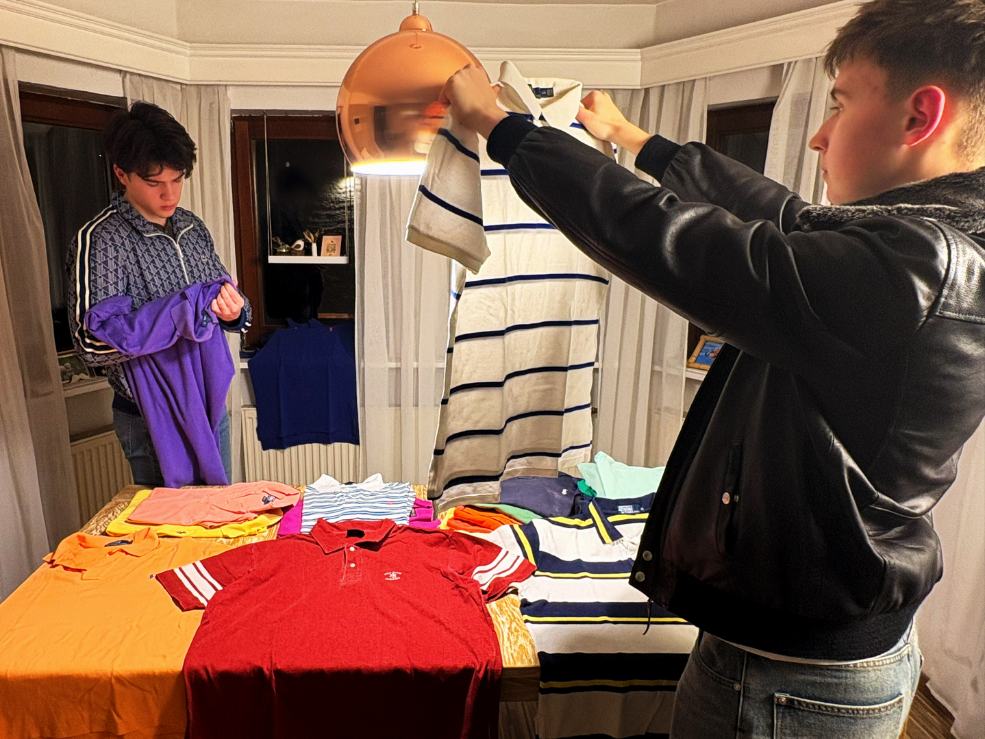 Young woman working on her clothing resale business from home