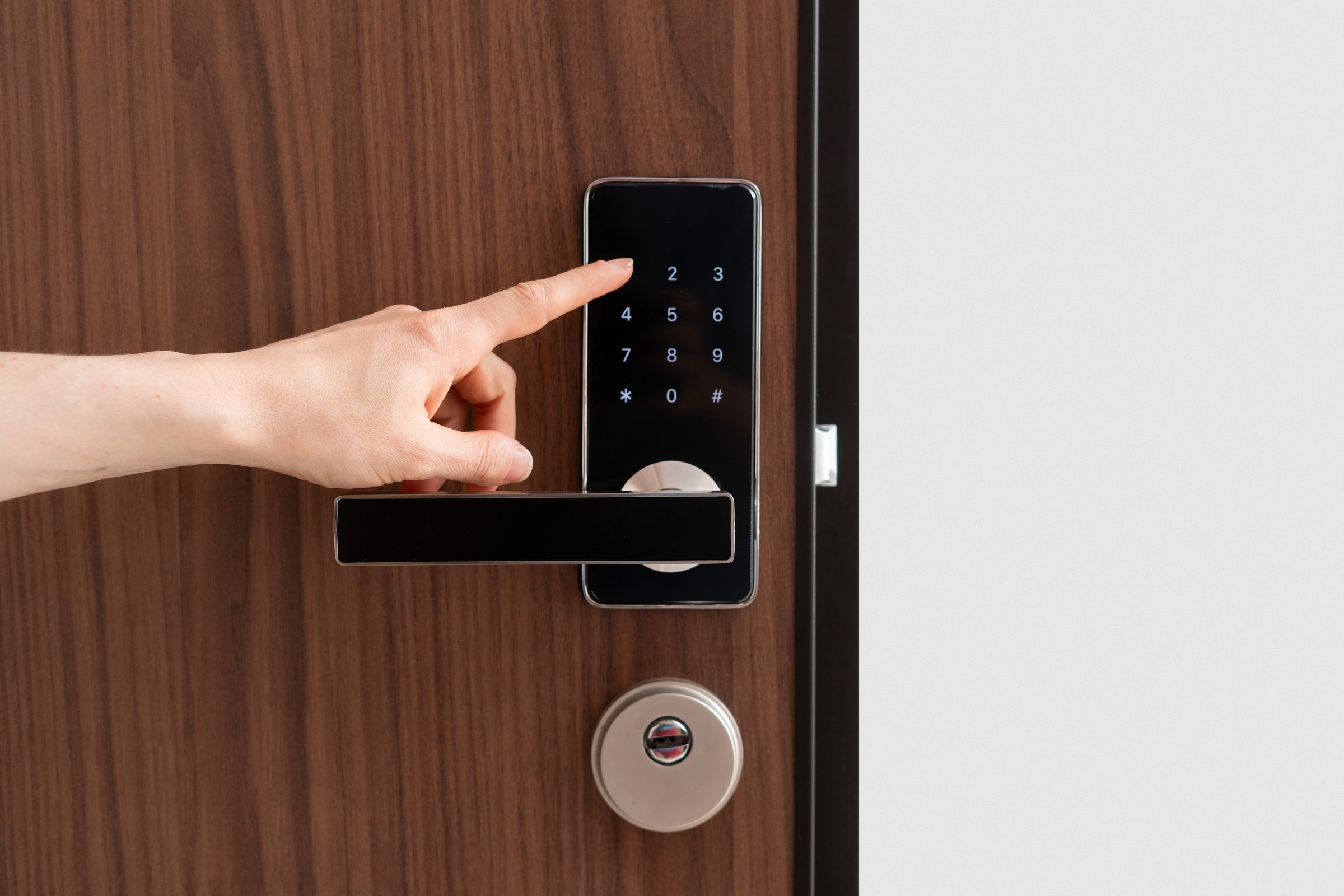 Person presses a button, enter pass code on digital lock with keypad. Digital technology, keyless system in hotel, privacy and security concepts