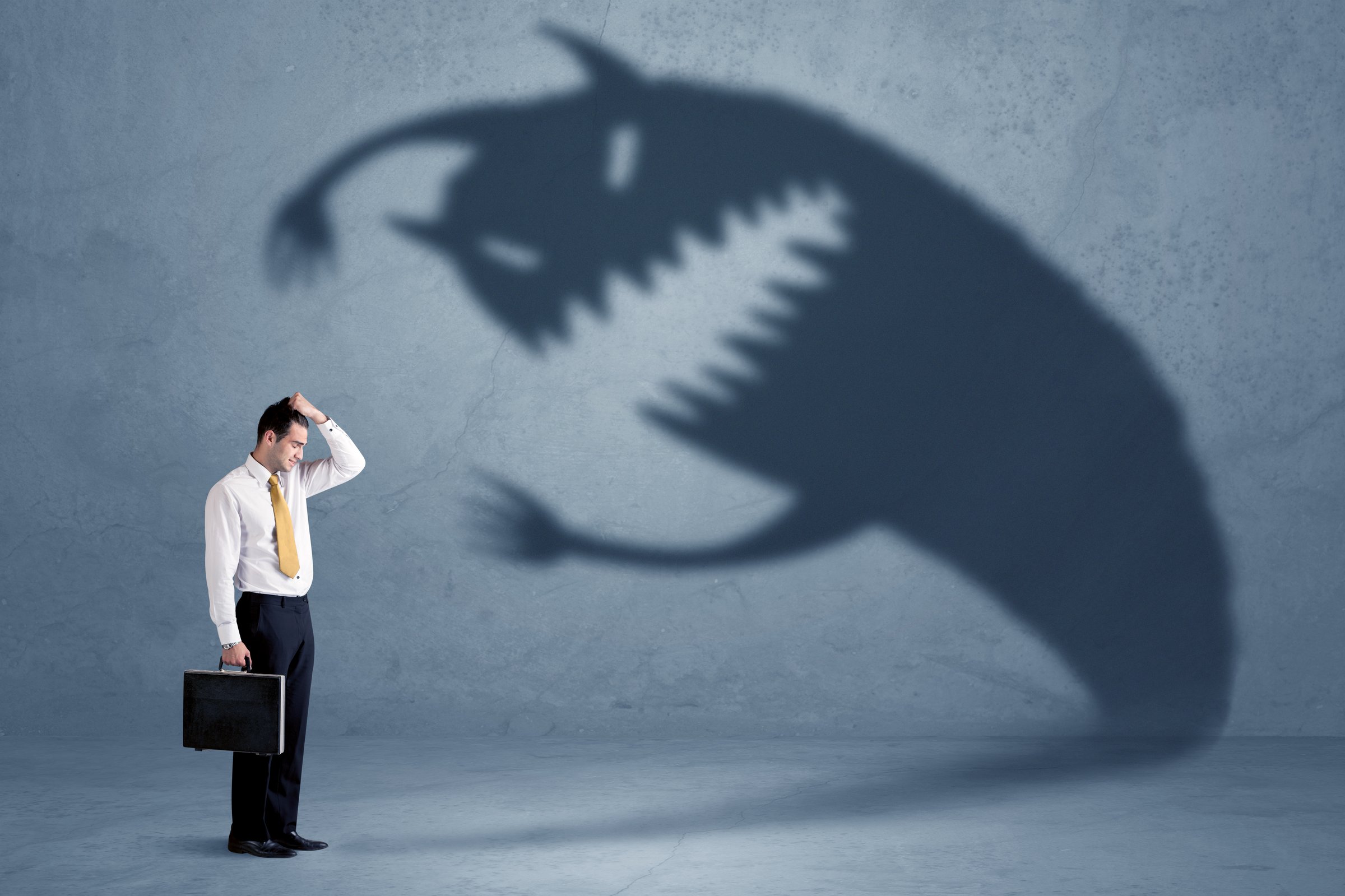 Business man afraid of his own shadow monster concept on grungy background