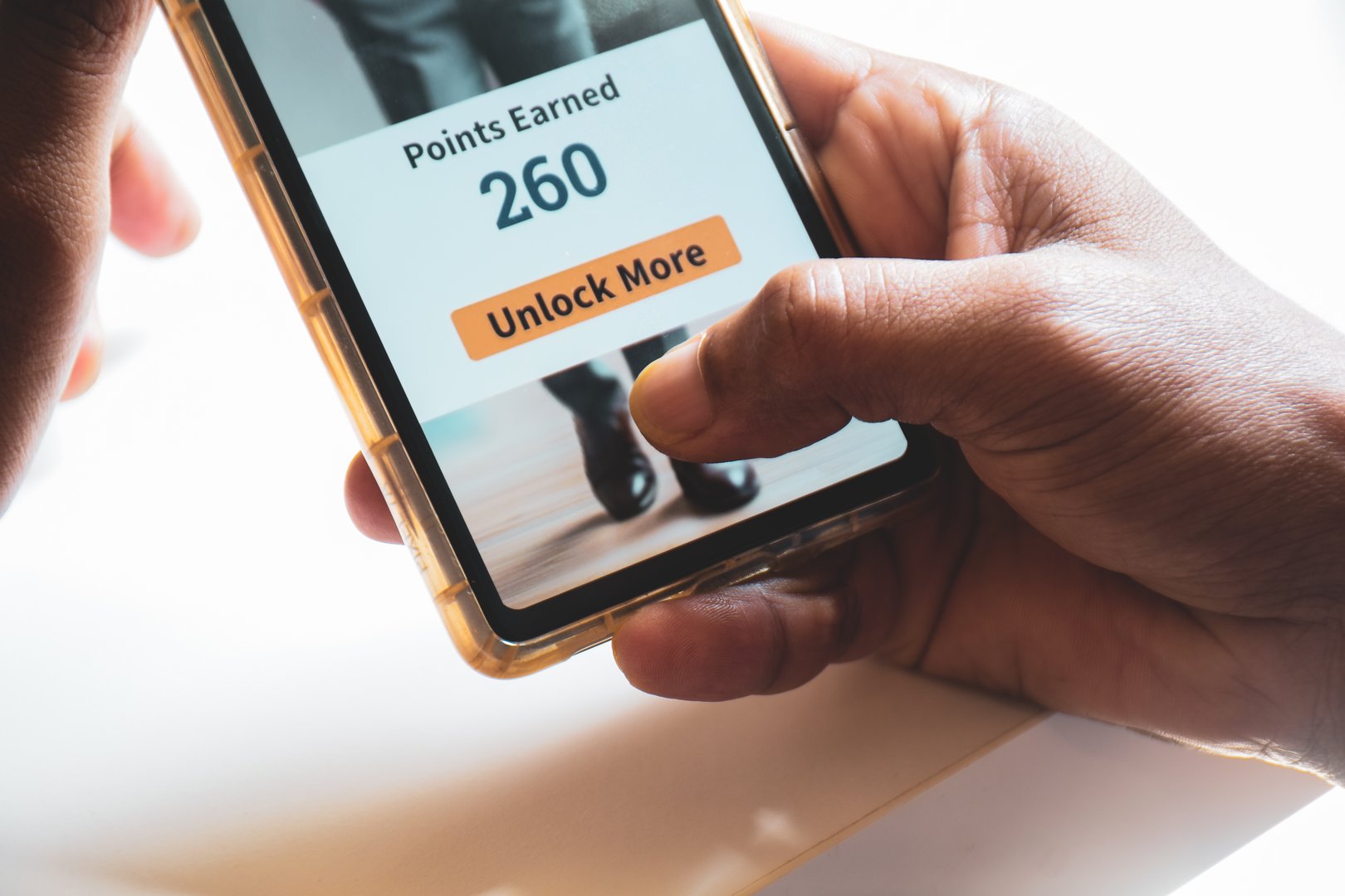 Mobile phone in hand man trying to accumulate points for future online purchase. Customer loyalty program strategy for social media engagement. Selective focus.