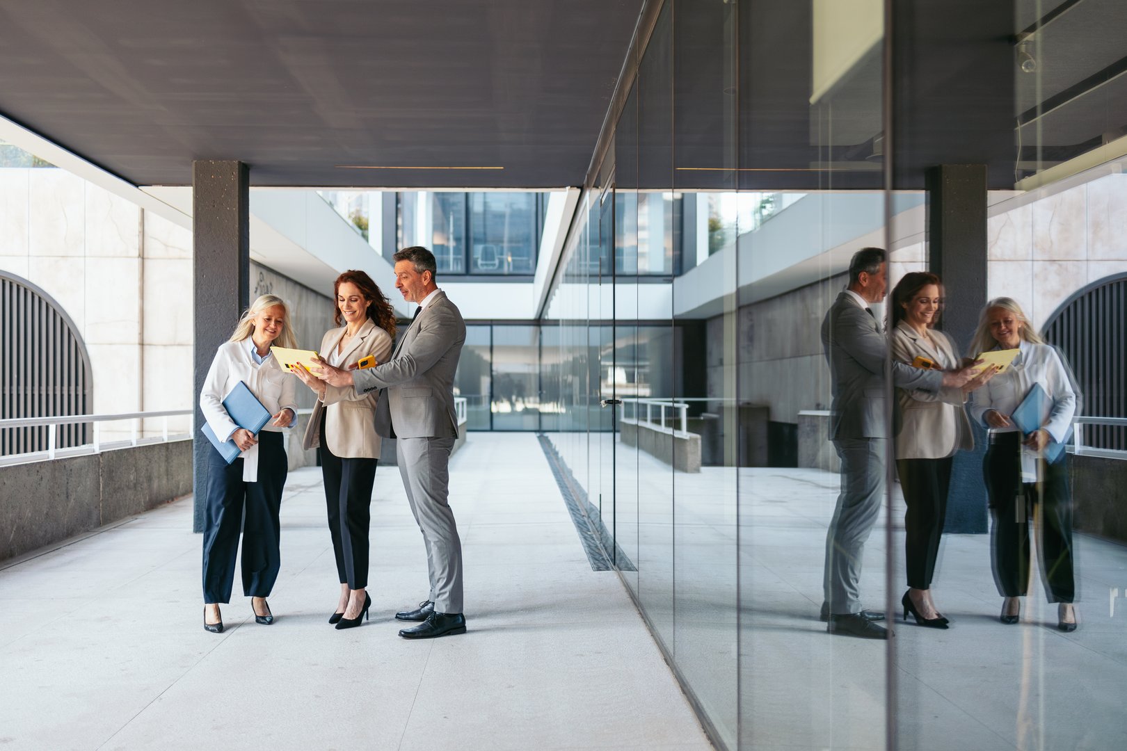 Business professionals reviewing contract in modern office
