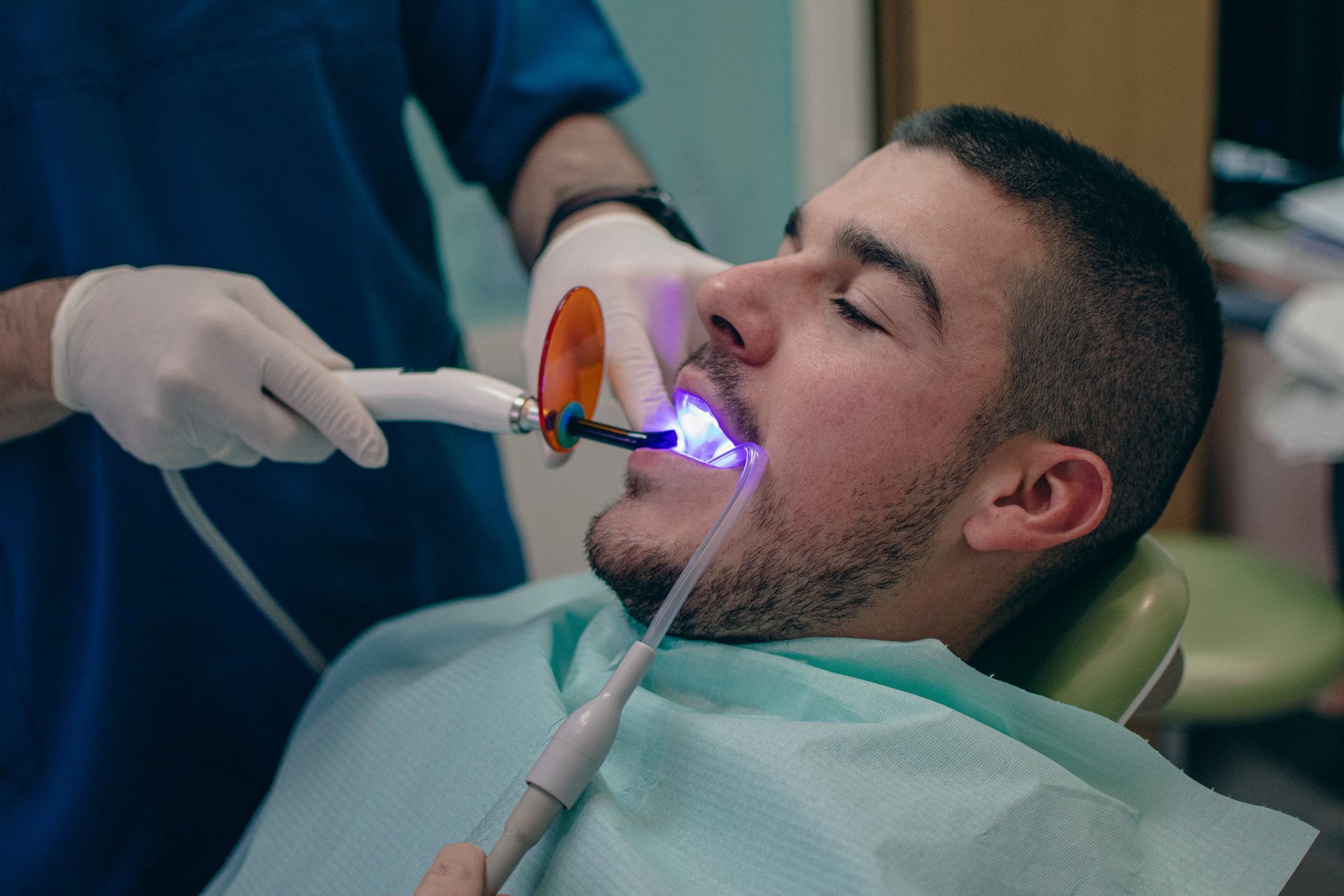 bonding the filling to the tooth with a polymerization lamp at the dentist
