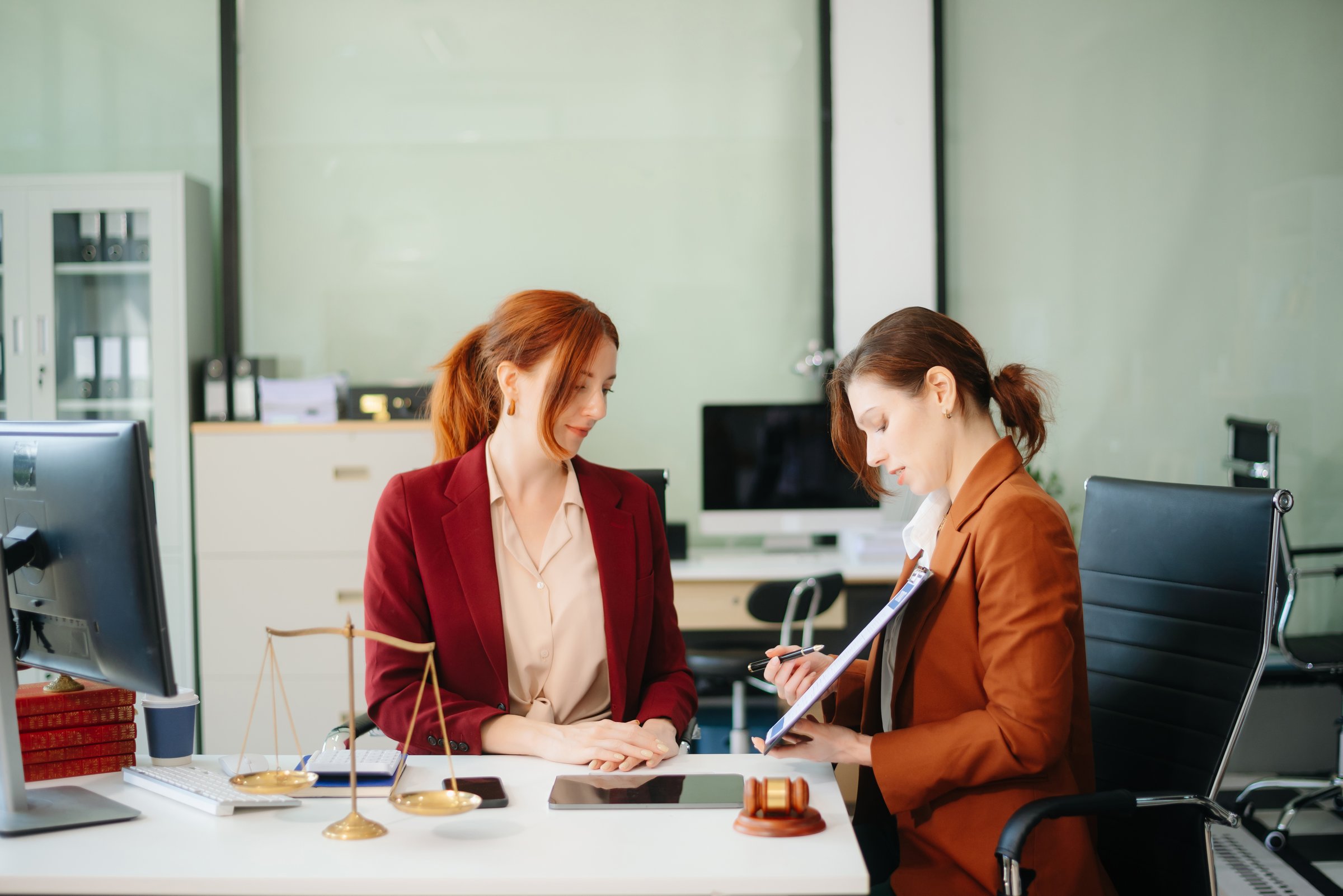 Business and lawyers discussing contract papers with brass scale on desk in office. Law, legal services, advice,  justice and law concept .