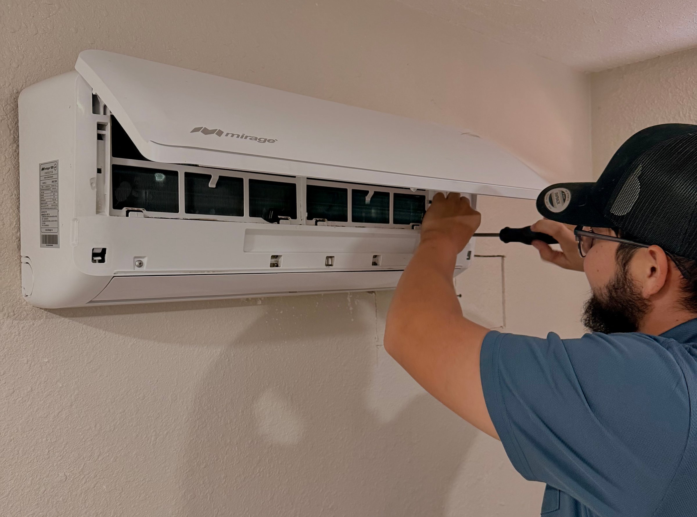 HVAC technician working on air conditioning unit