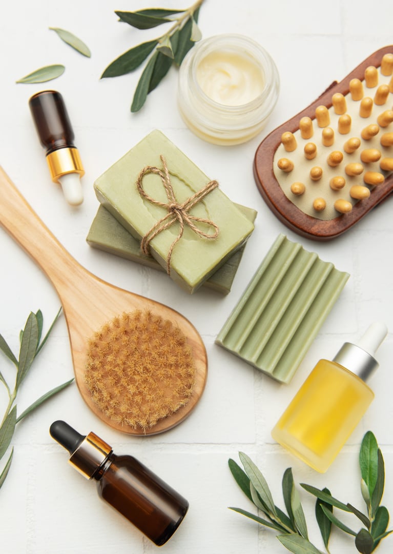 Olive oil beauty products and massage brushes are creating a relaxing spa kit for skin and body care