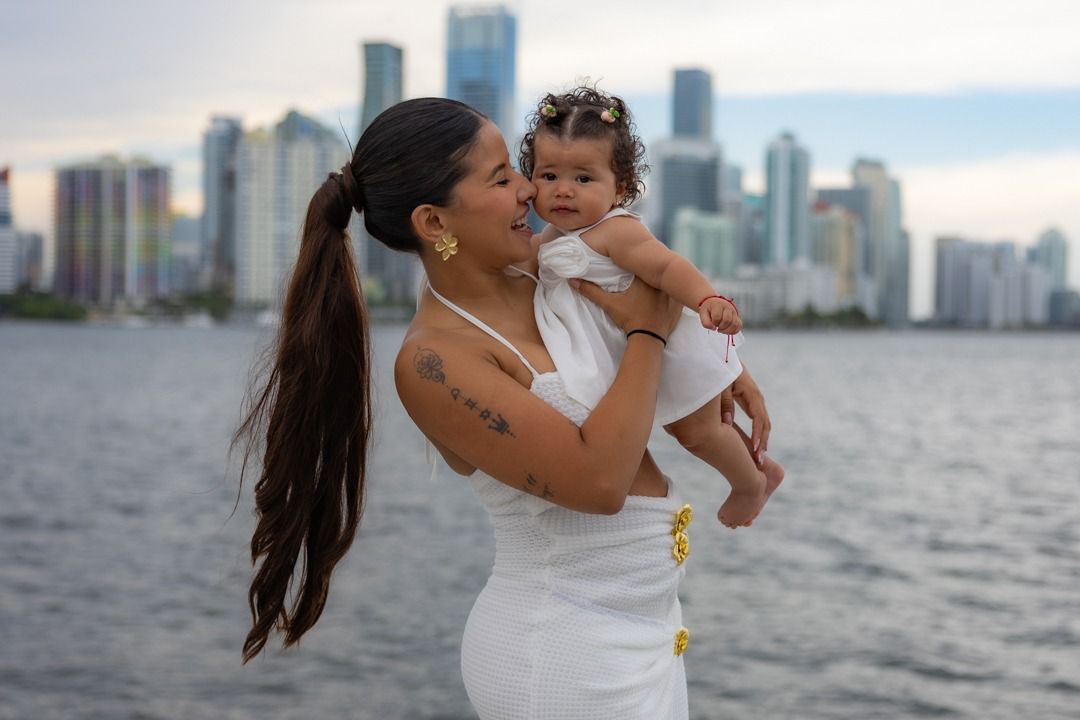 Photographer smiling and taking pictures with professional camera in a studio