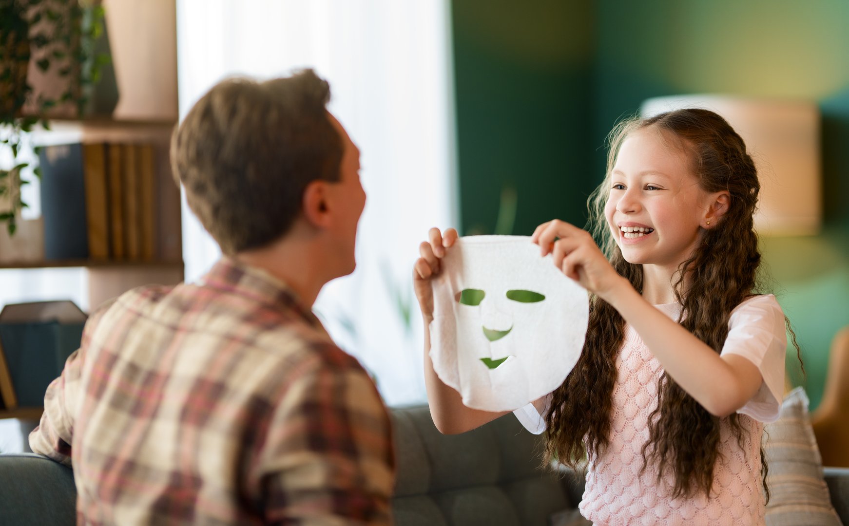 Funny family! Father and his child daughter with a face mask.
