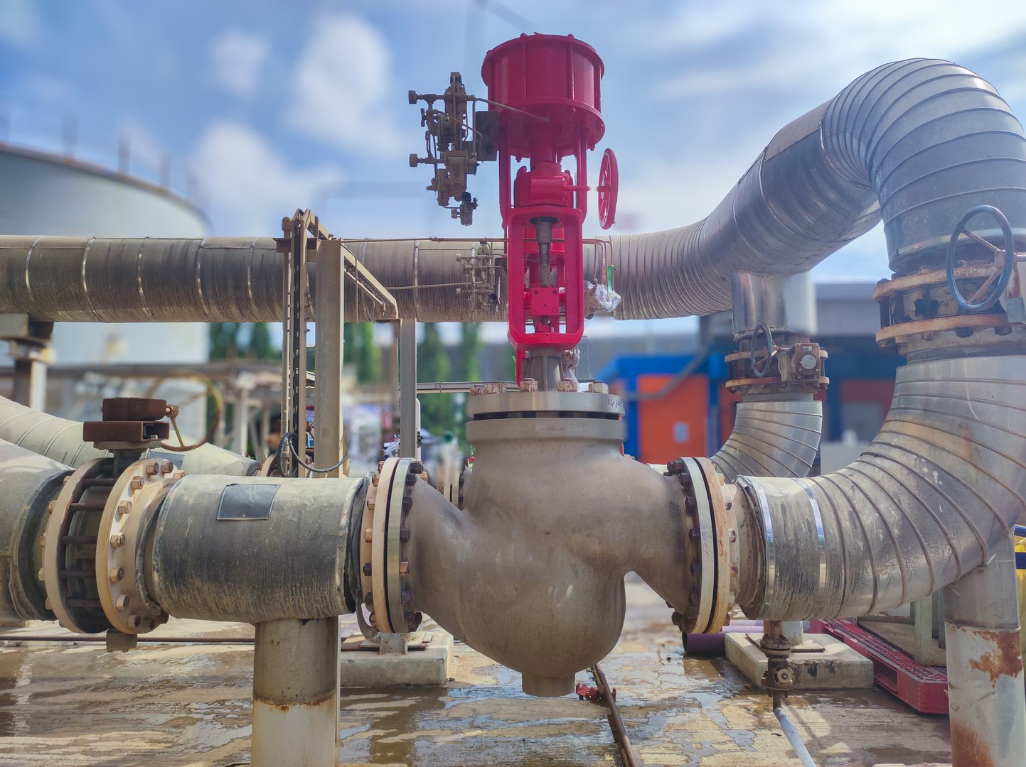 red big Pneumatic control valve that uses air instruments to regulate opening and closing