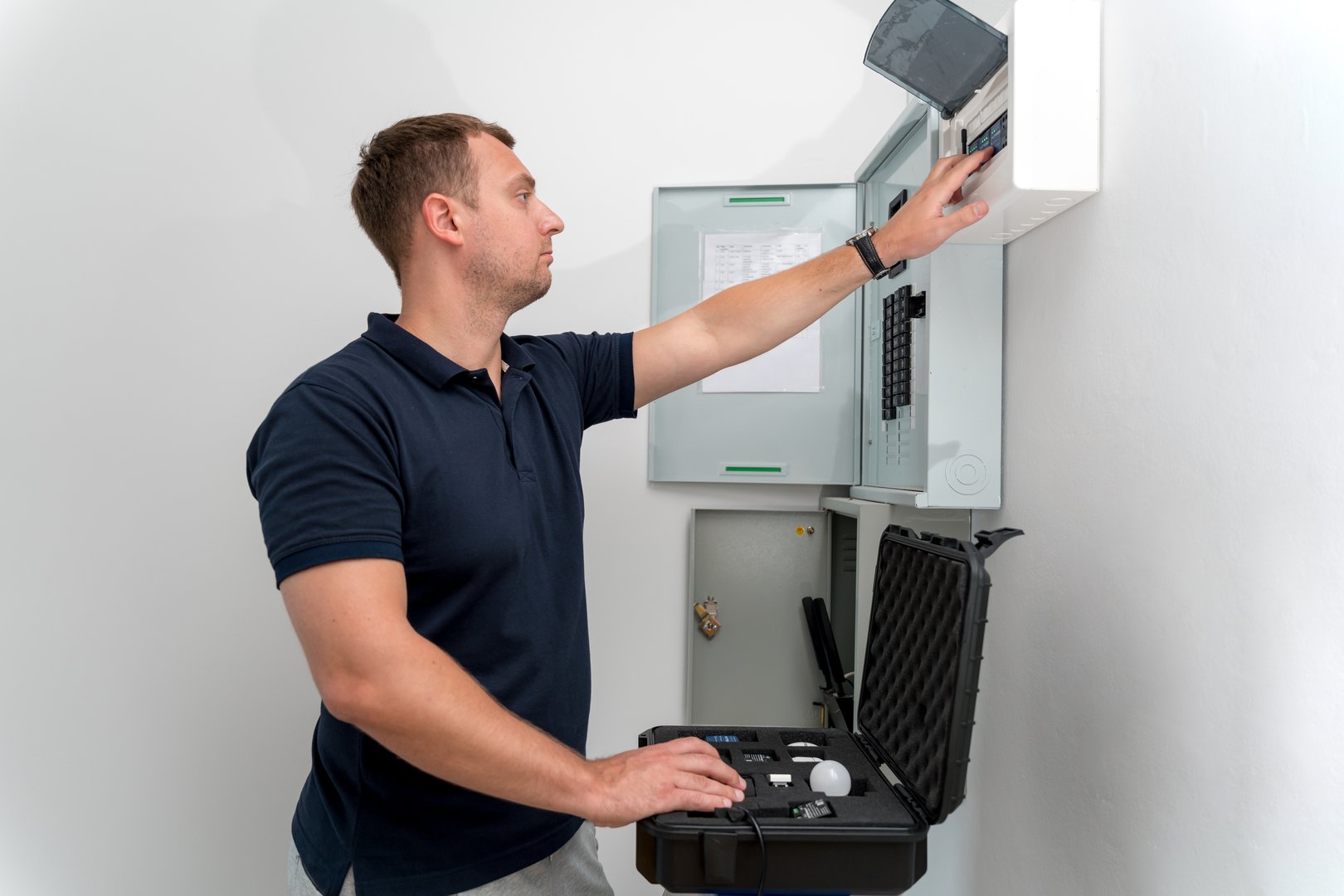 A technician works with a demo kit of the smart home system.