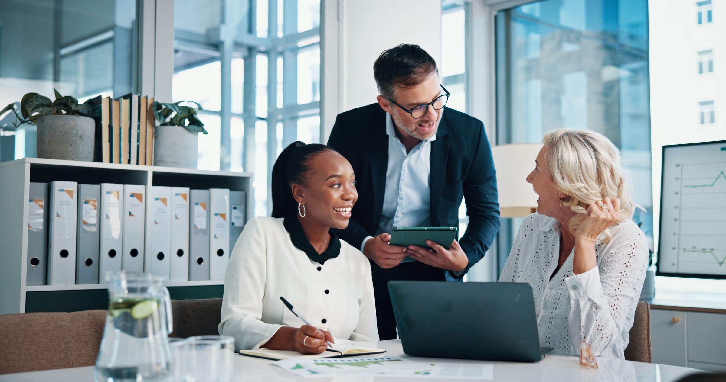 Accounting, office and business people with meeting, feedback and manager for laptop, discussion and graphs. Training, teamwork and talk with tablet, growth strategy or project report for finance