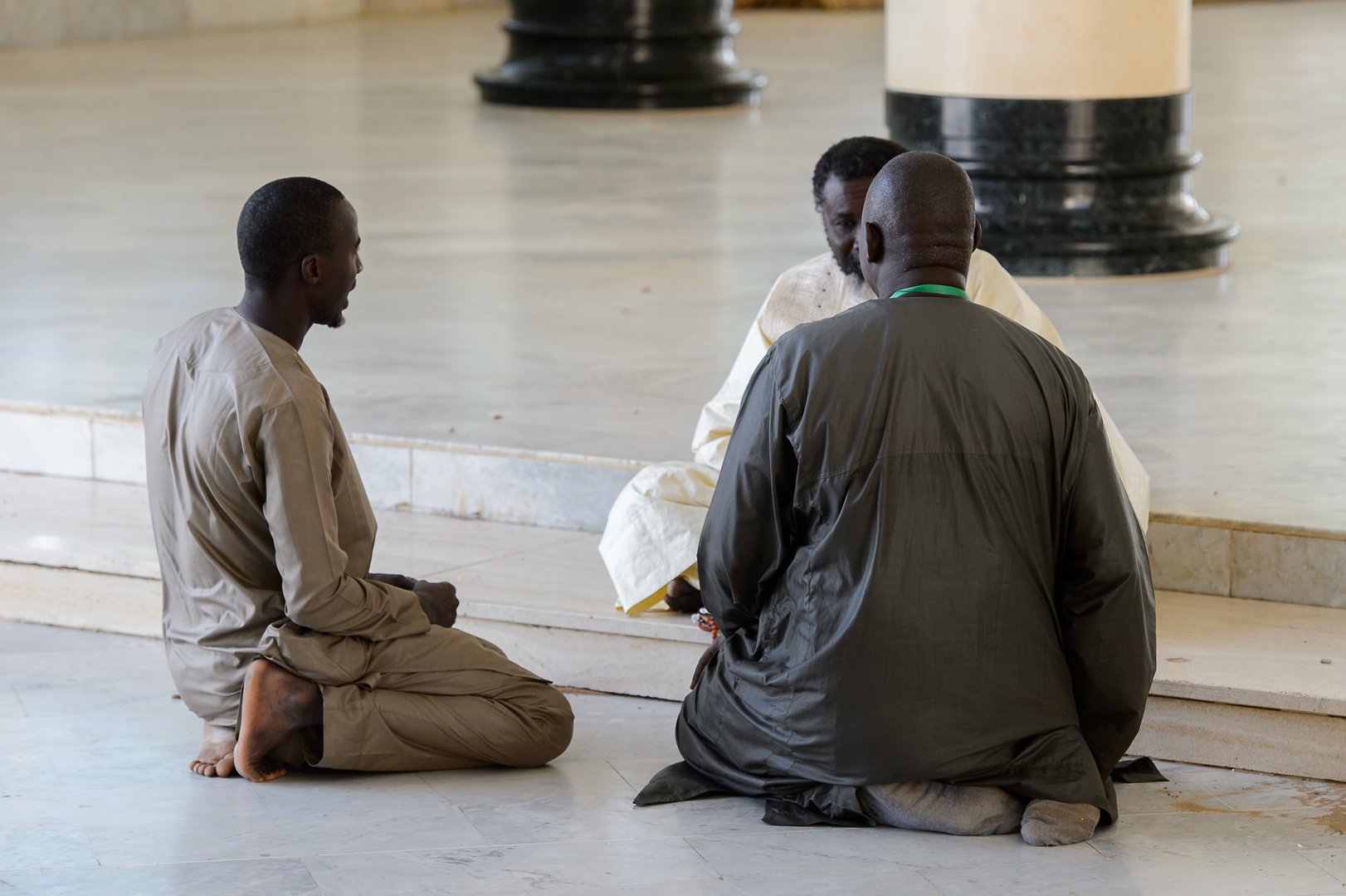 TOUBA, SENEGAL - APR 26, 2017: Unidentified Senegalese people talk with a mullah on the floor in the Great Mosque of Touba, the home of the Mouride Brotherhood