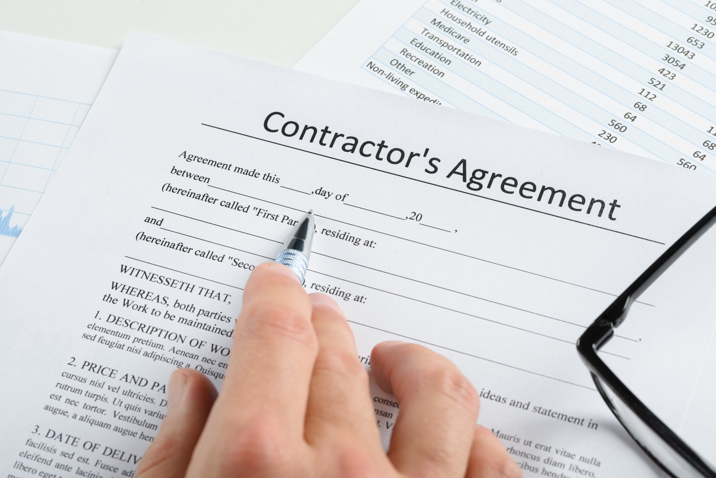 Professional working on contractor agreement