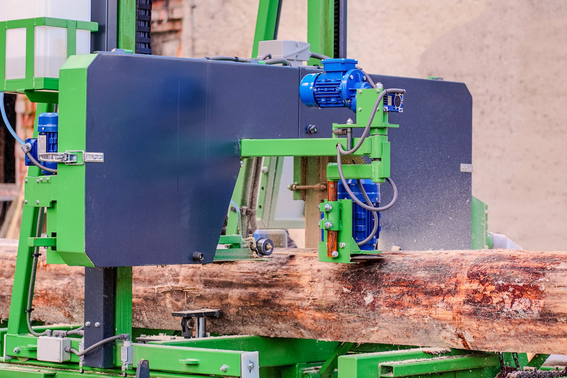 Sawmill on wood manufacture. Electric saw cutting through log outdoors, with sawdust from pine tree. Highlighting processes involved in timber and lumber industry.