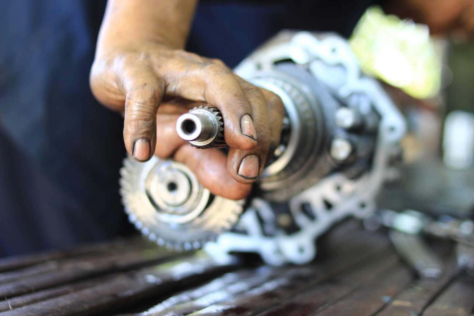 Mechanic repairing car transmission