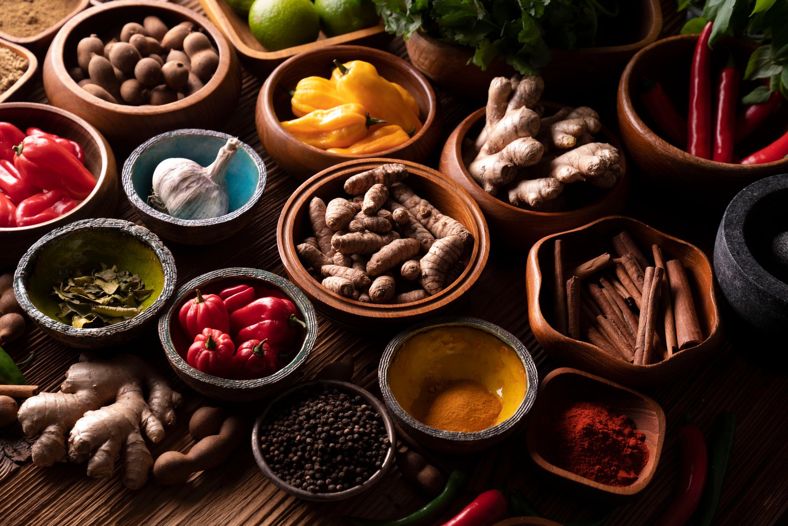 Ingredients in teak bowls on rustic wooden table.