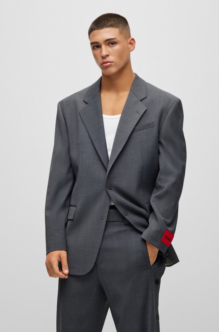 Professional male model wearing Hugo Boss suit in high-end fashion campaign
