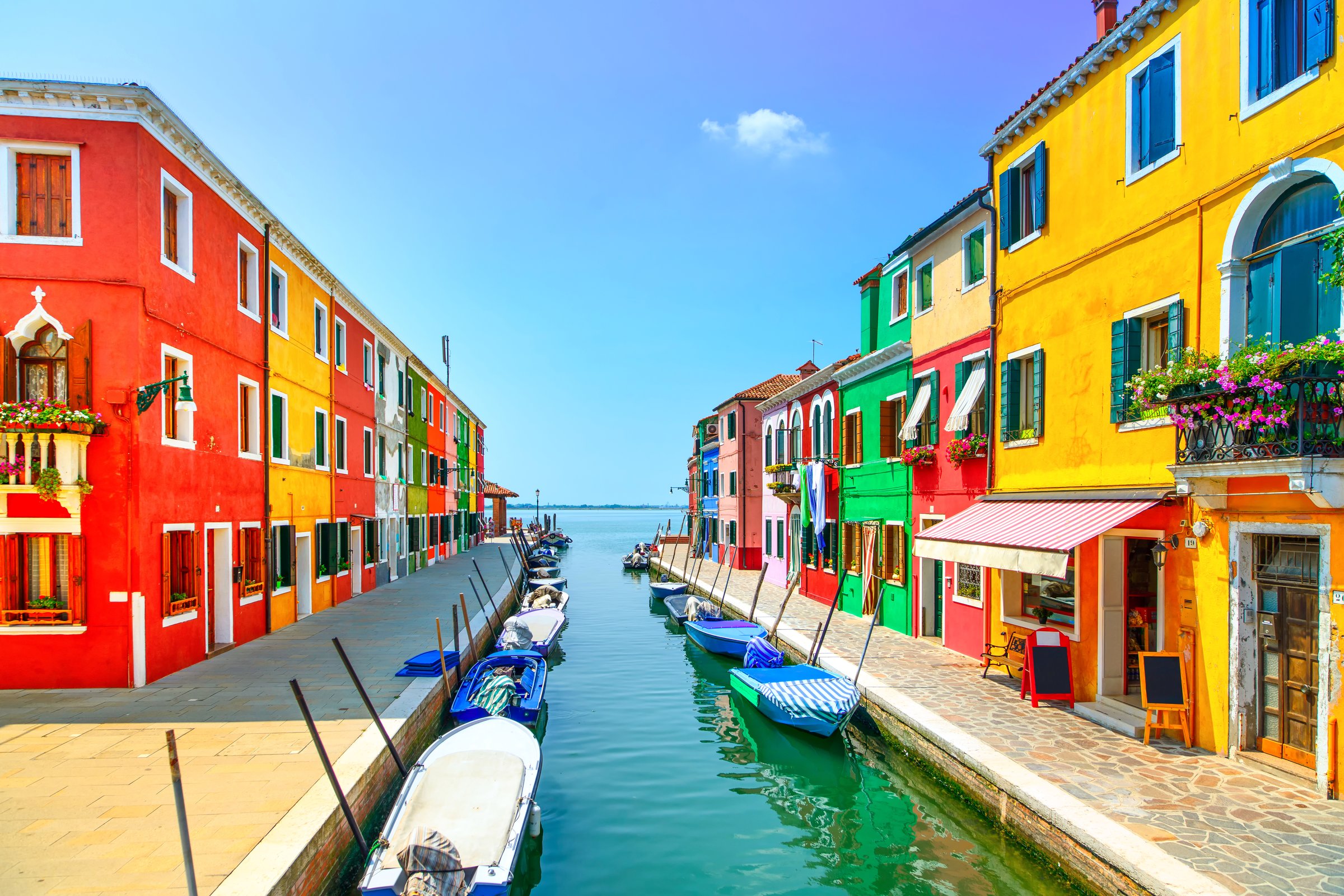 Venice landmark, Burano island canal, colorful houses and boats, Italy. Long exposure photography