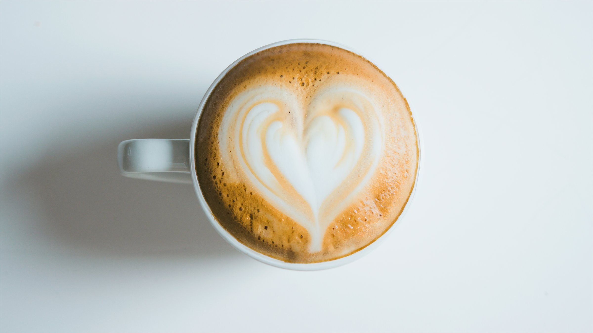 Overhead View Of Fresh Coffee With Heart Shape Art Design In Foam