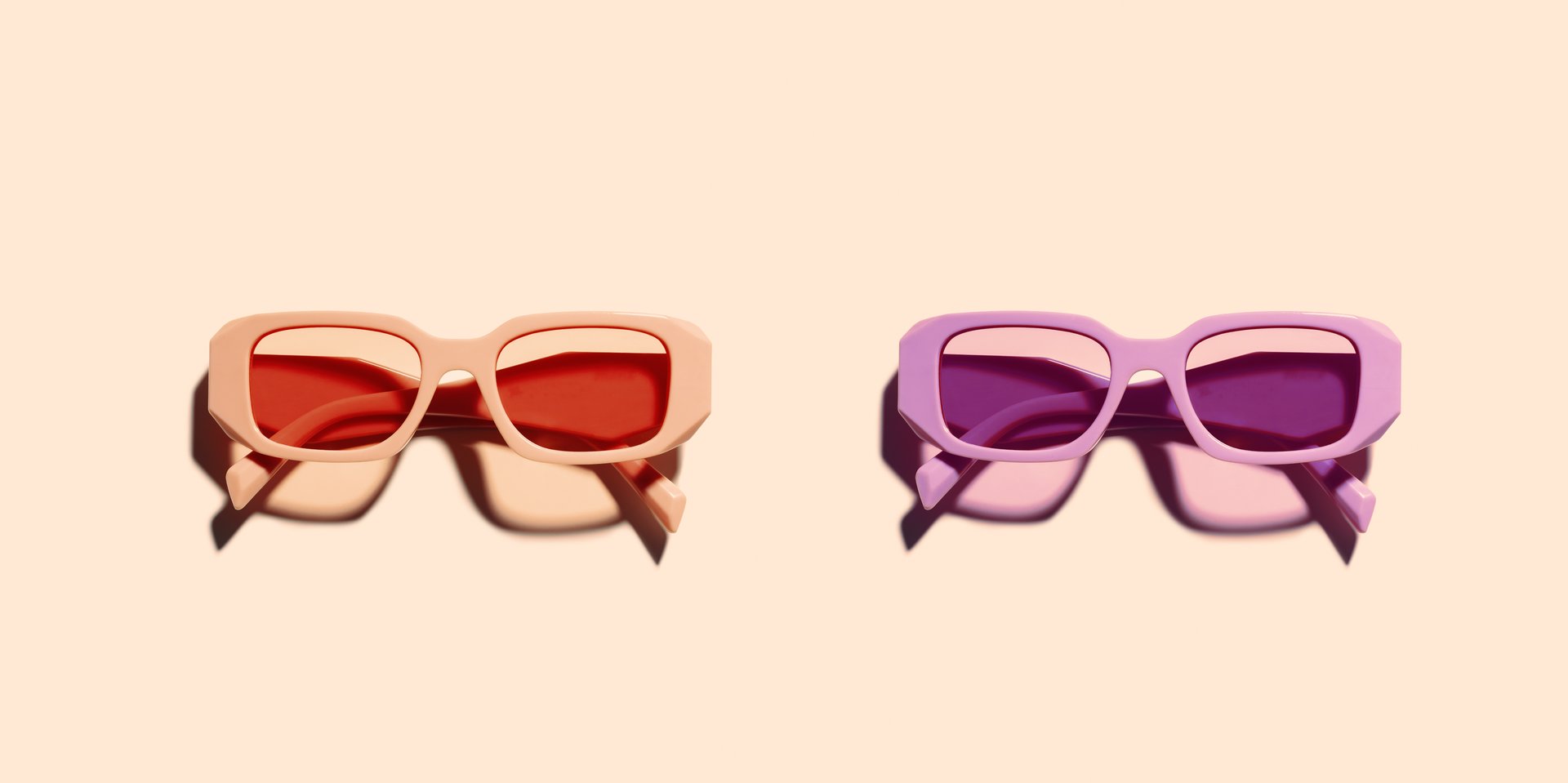 Trendy sunglasses with red pink and violet Frame on beige background, copyspace, beach vibes, summertime mood, sunlight shadow and glare, summer fashion vivid glasses. Minimal top view of eyeglasses