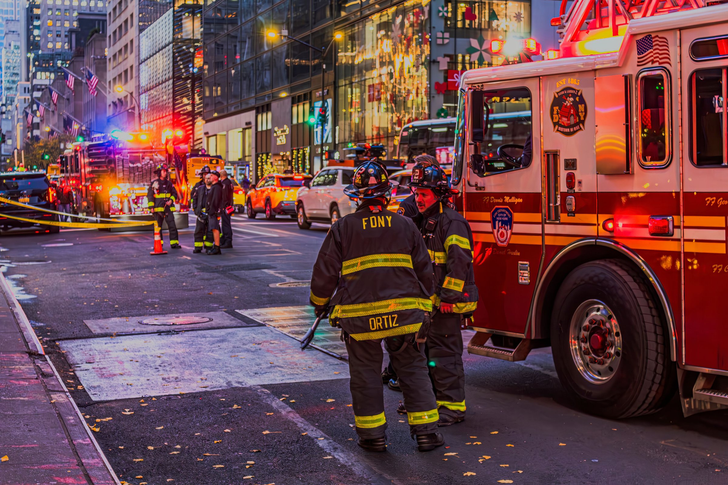 New York, United States – November 29, 2024: Firefighters beside a firetruck on Fifth Avenue during early evening in NYC