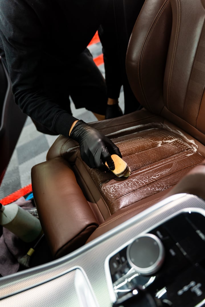 Brown leather seat detailing removes dirt, dust, and stains using a brush and safe detergent. Deep cleaning brown leather car seats with brushes and specialized chemicals