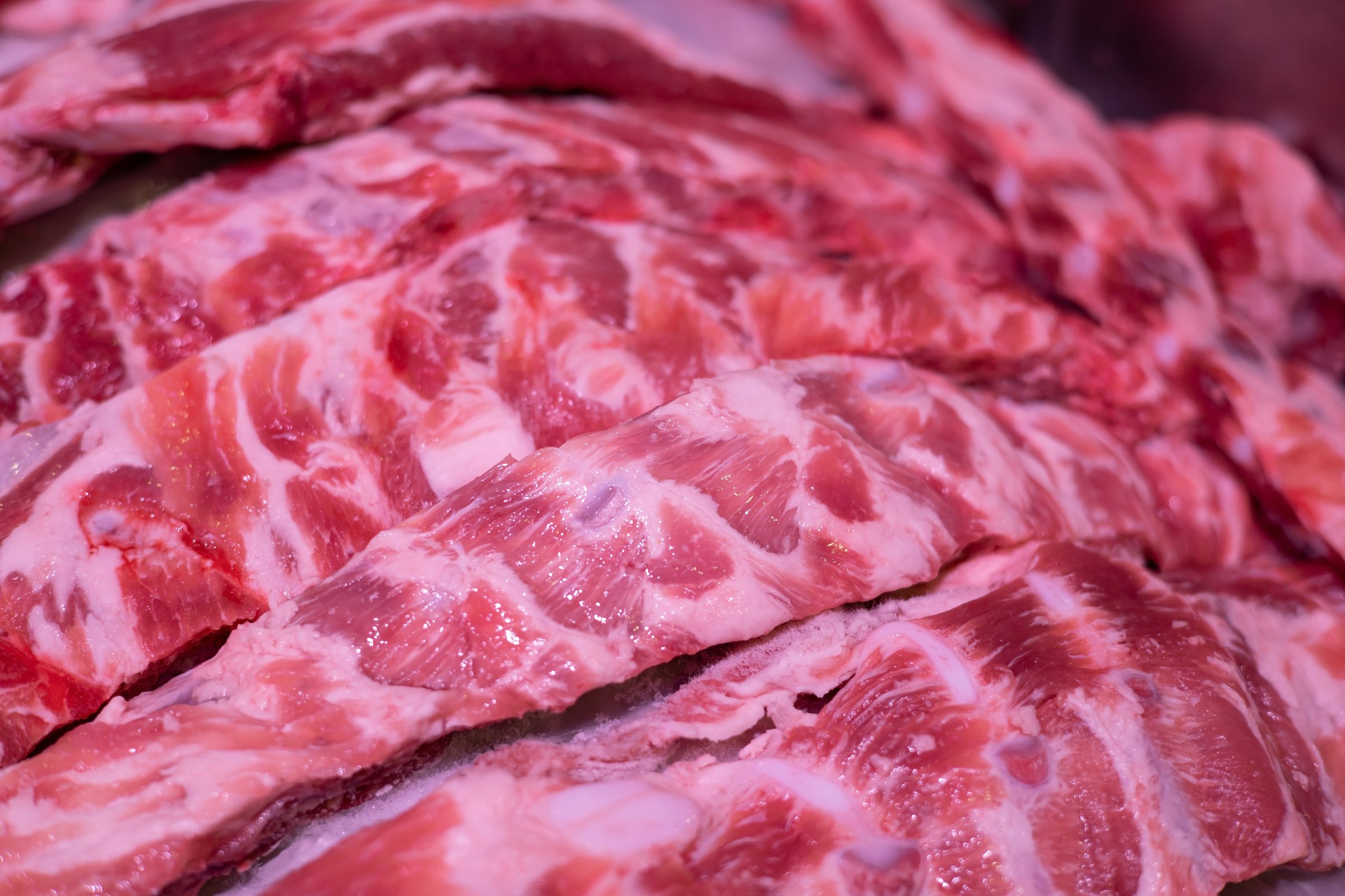 The pork belly is freshly sold in the market for cooking.