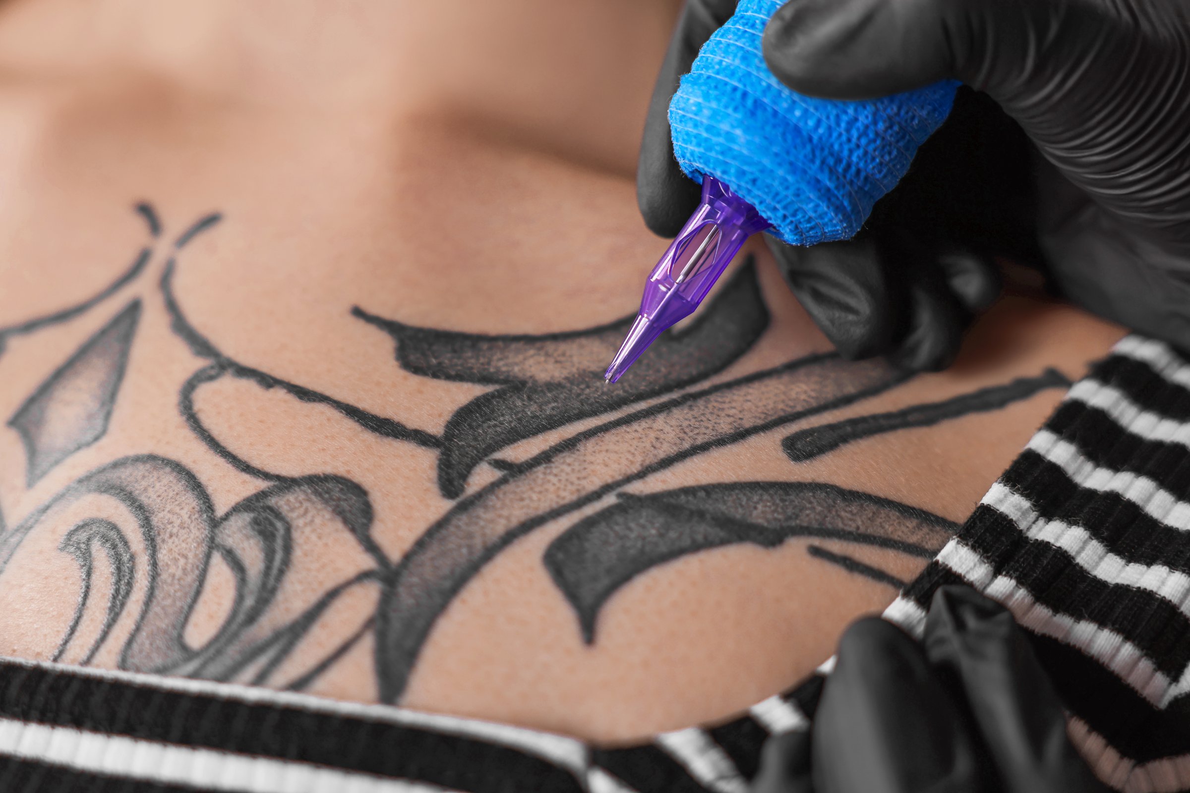Artist tattooing close-up