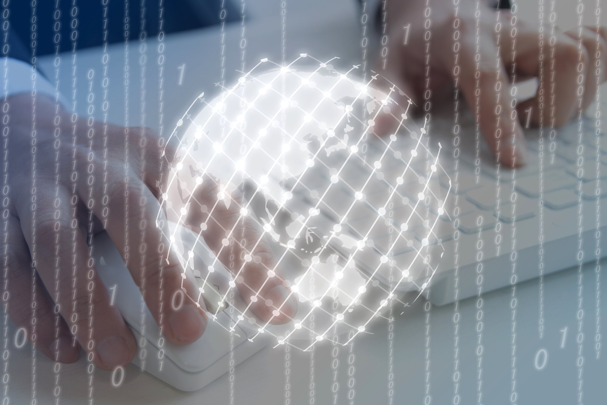 Business man's hands using PC with earth and vinary code screen
