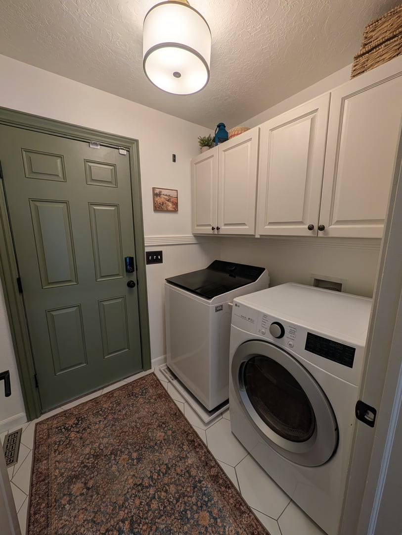 Final result of laundry room makeover with Behr Swiss Coffee walls and Even Better Beige cabinets