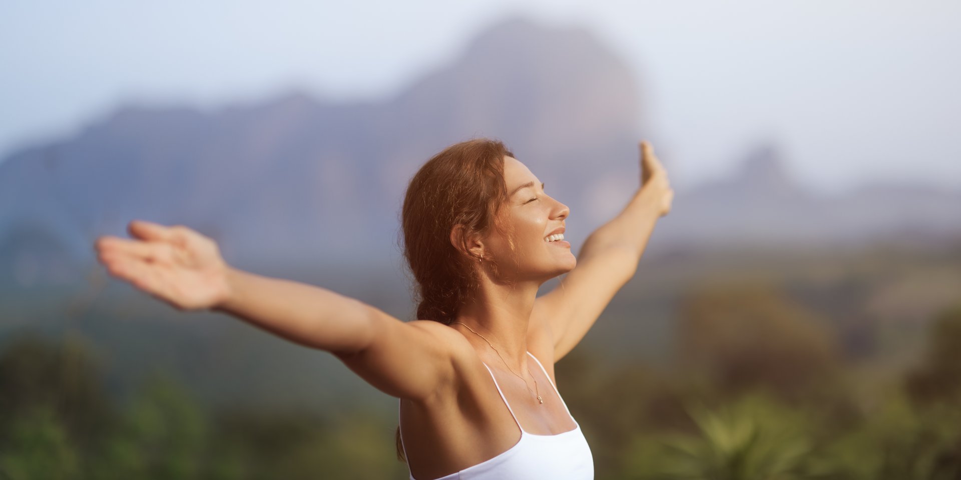 Young woman feeling free and vibrant in nature