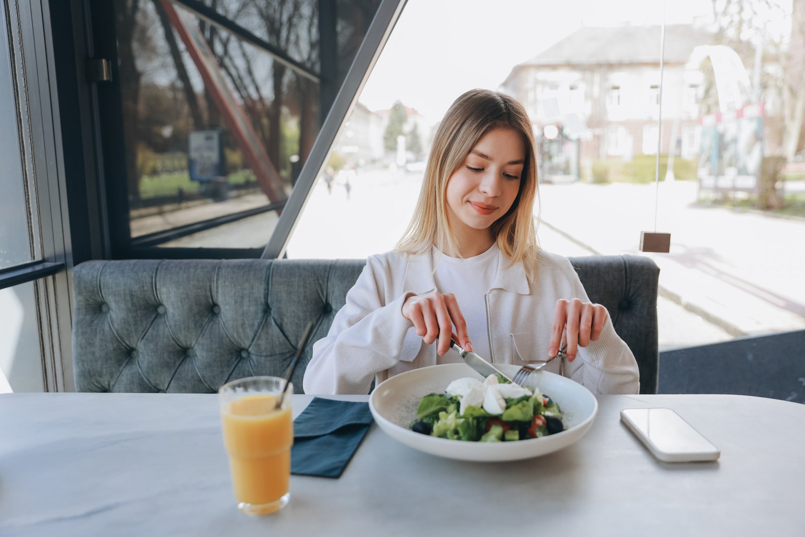 Happy customer enjoying a healthy meal in a modern restaurant, promoting a balanced lifestyle and mindful eating habits