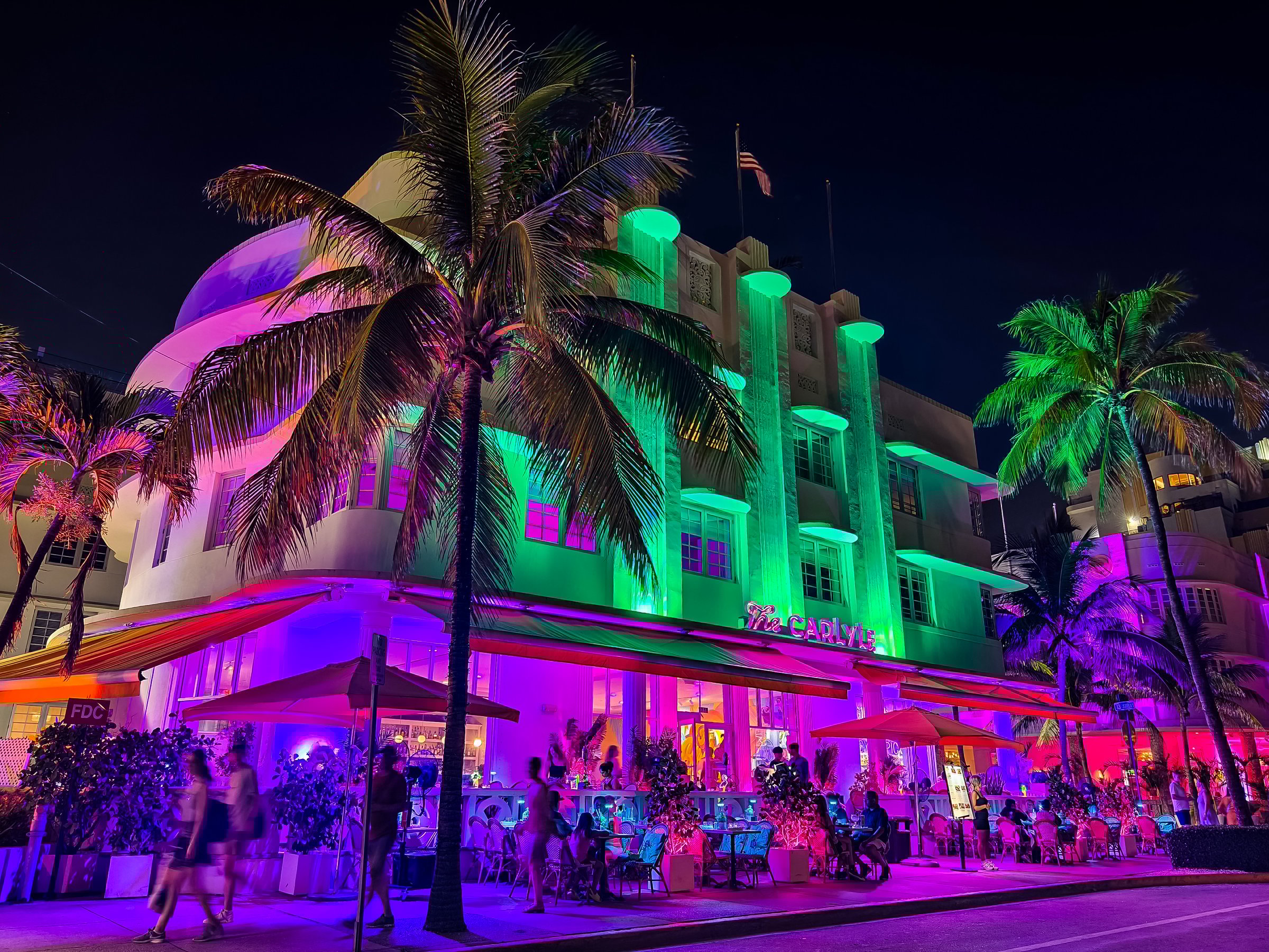 Miami Beach, Florida - July 8, 2024: Vibrant night scene of The Carlyle at Ocean Drive, South Beach.