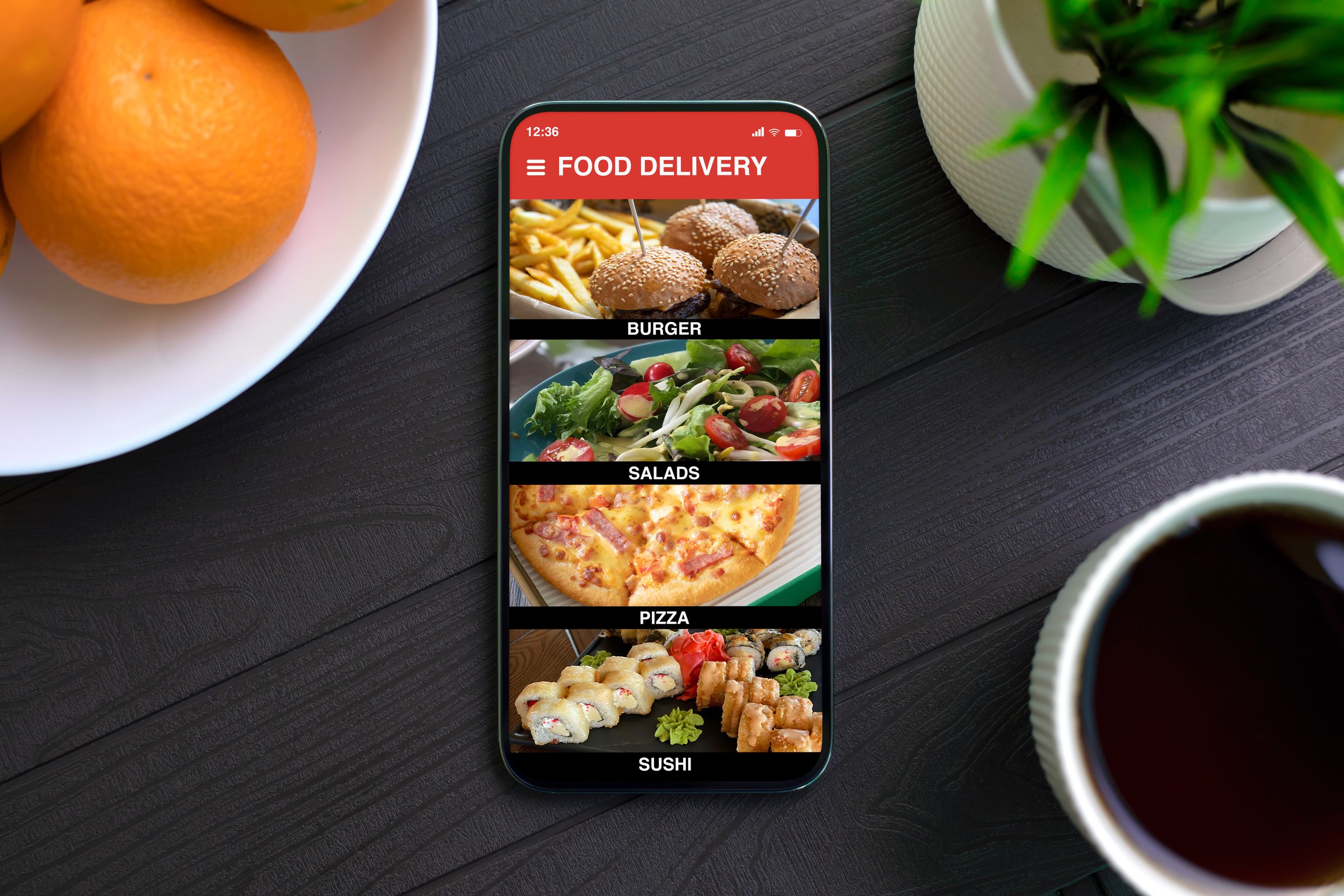 phone with food delivery application on the screen background of dark table in cafe