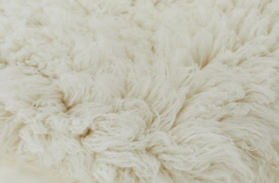 Flokati shag rug with soft fluffy white wool texture - professional cleaning for delicate high-pile rugs