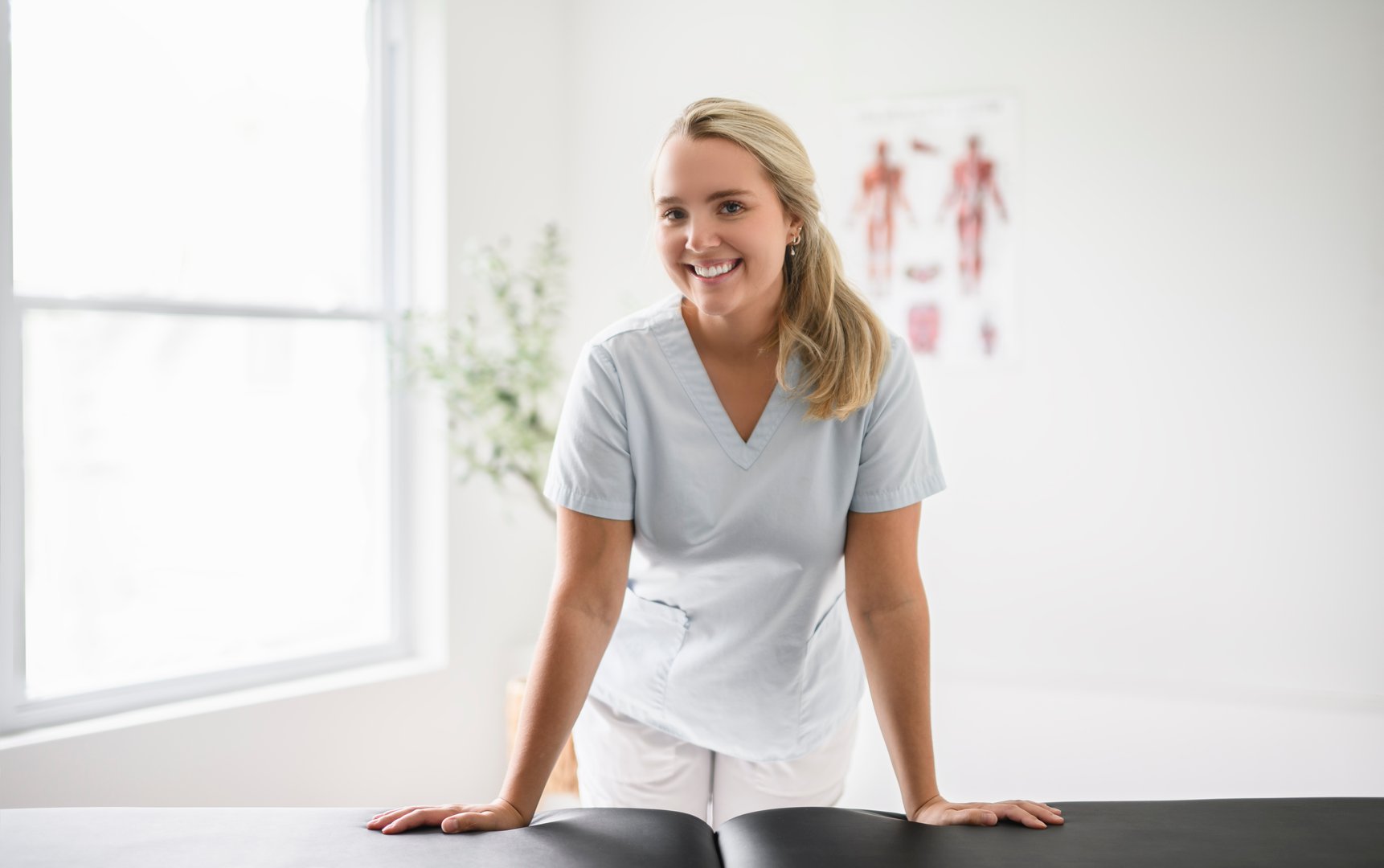 A nice blond physiotherapist woman at job